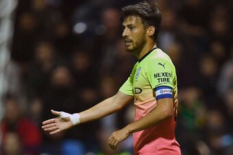 Manchester City's Spanish midfielder David Silva celebrates after Preston's English midfielder Ryan Ledson (unseen) scored an own goal, City's third goal, during the English League Cup third round football match between Preston North End and Manchester Ci