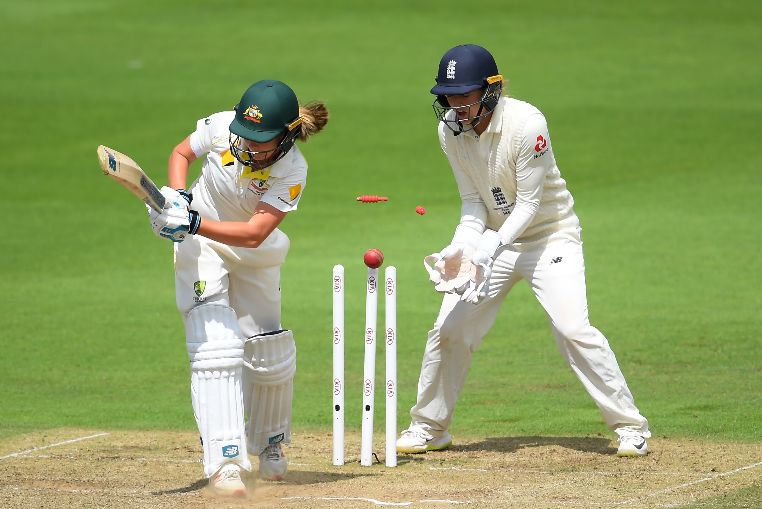 TAUNTON, ENGLAND - JULY 20: Sophie Molineux of Australia  of Australia is bowled by Sophie Ecclestone (not pictured) of England watched on by Sarah Taylor of England during Day Three of the Kia Women's Test Match between England Women and Australia Women 