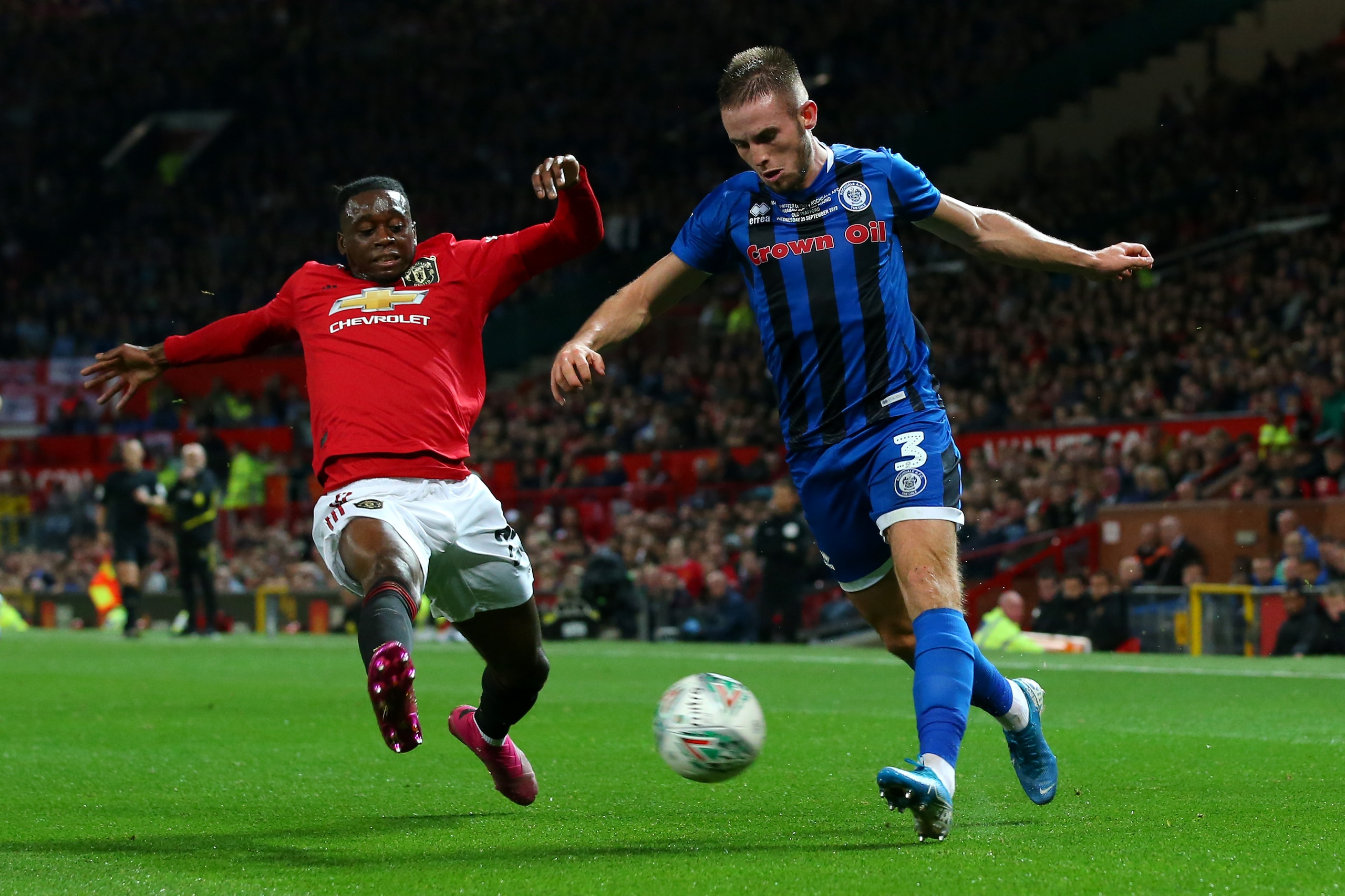 MANCHESTER, ENGLAND - SEPTEMBER 25:  Aaron Wan-Bissaka of Manchester United tackles Rhys Norrington-Davies of Rochdale during the Carabao Cup Third Round match between Manchester United and Rochdale AFC at Old Trafford on September 25, 2019 in Manchester,