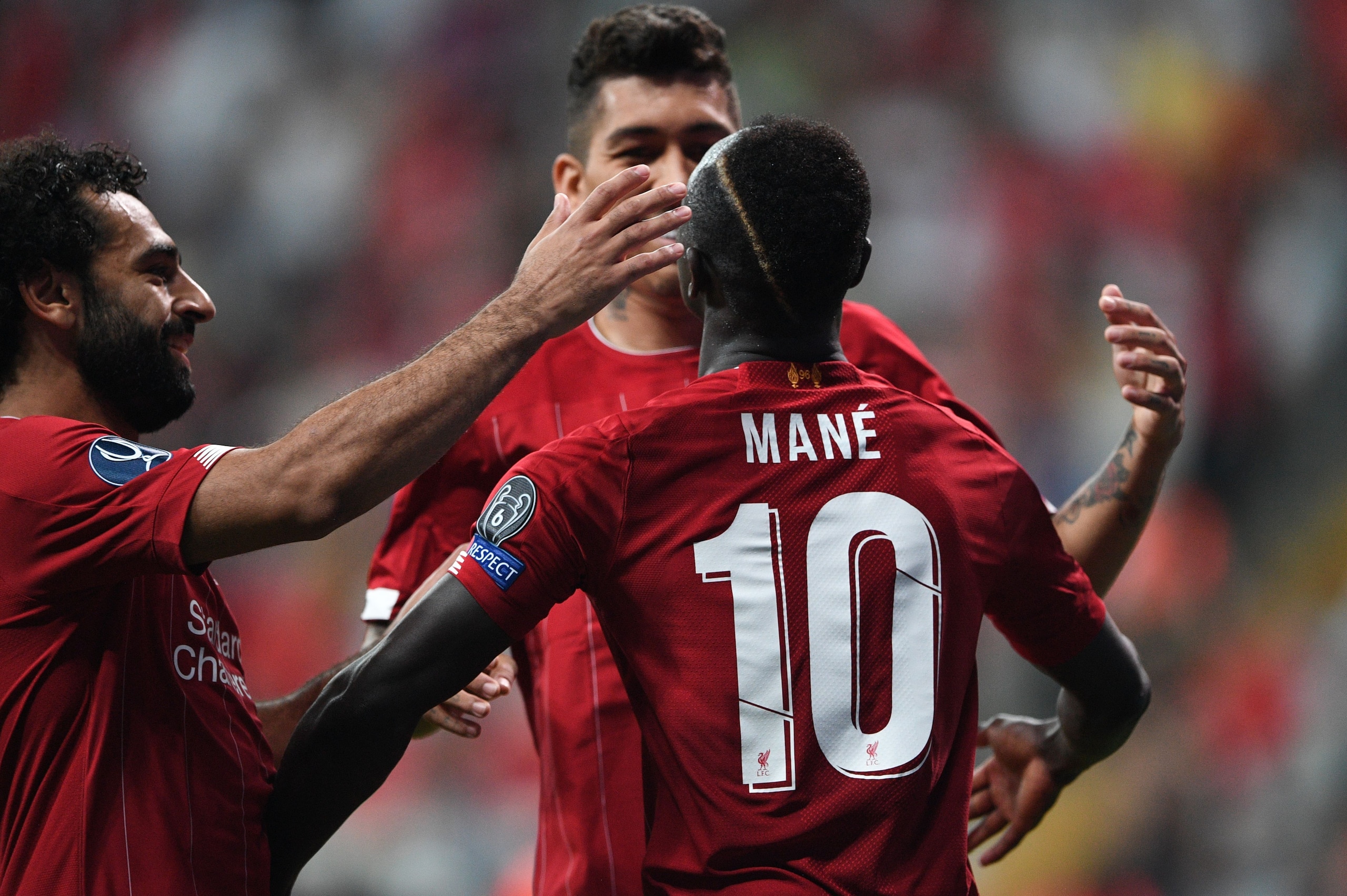Liverpool's Senegalese striker Sadio Mane (R) celebrates with teammates Liverpool's Egyptian midfielder Mohamed Salah (L) and Liverpool's Brazilian midfielder Roberto Firmino after scoring a goal during the UEFA Super Cup 2019 football match between FC Li