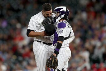 DENVER, COLORADO - SEPTEMBER 11: Pitcher Carlos Estevez #54 and catcher Tony Wolters #14 of the Colorado Rockies confer in the eighth inning against the St Louis Cardinals at Coors Field on September 11, 2019 in Denver, Colorado. (Photo by Matthew Stockma