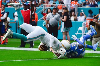 MIAMI, FL - SEPTEMBER 29: Desmond King #20 of the Los Angeles Chargers tackles Josh Rosen #3 of the Miami Dolphins during the third quarter of the game at Hard Rock Stadium on September 29, 2019 in Miami, Florida. (Photo by Eric Espada/Getty Images)