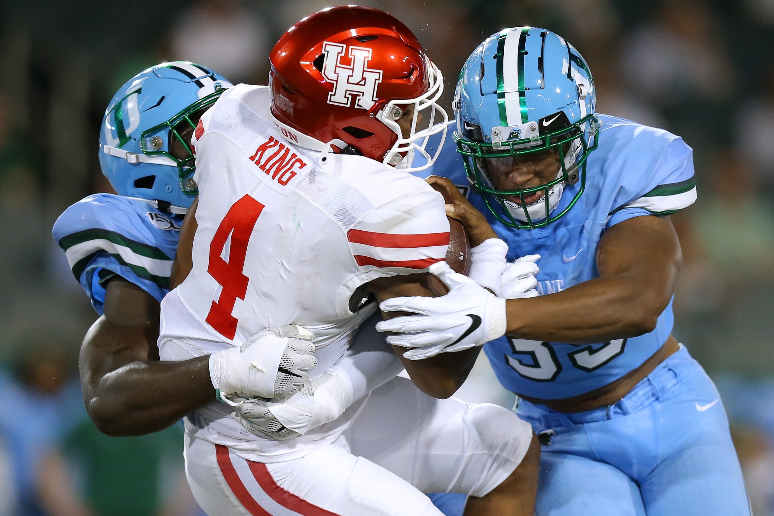 NEW ORLEANS, LOUISIANA - SEPTEMBER 19: D'Eriq King #4 of the Houston Cougars is sacked by Cameron Sample #5 of the Tulane Green Wave of the Tulane Green Wave and Lawrence Graham #35 during the first half of a game at Yulman Stadium on September 19, 2019 i