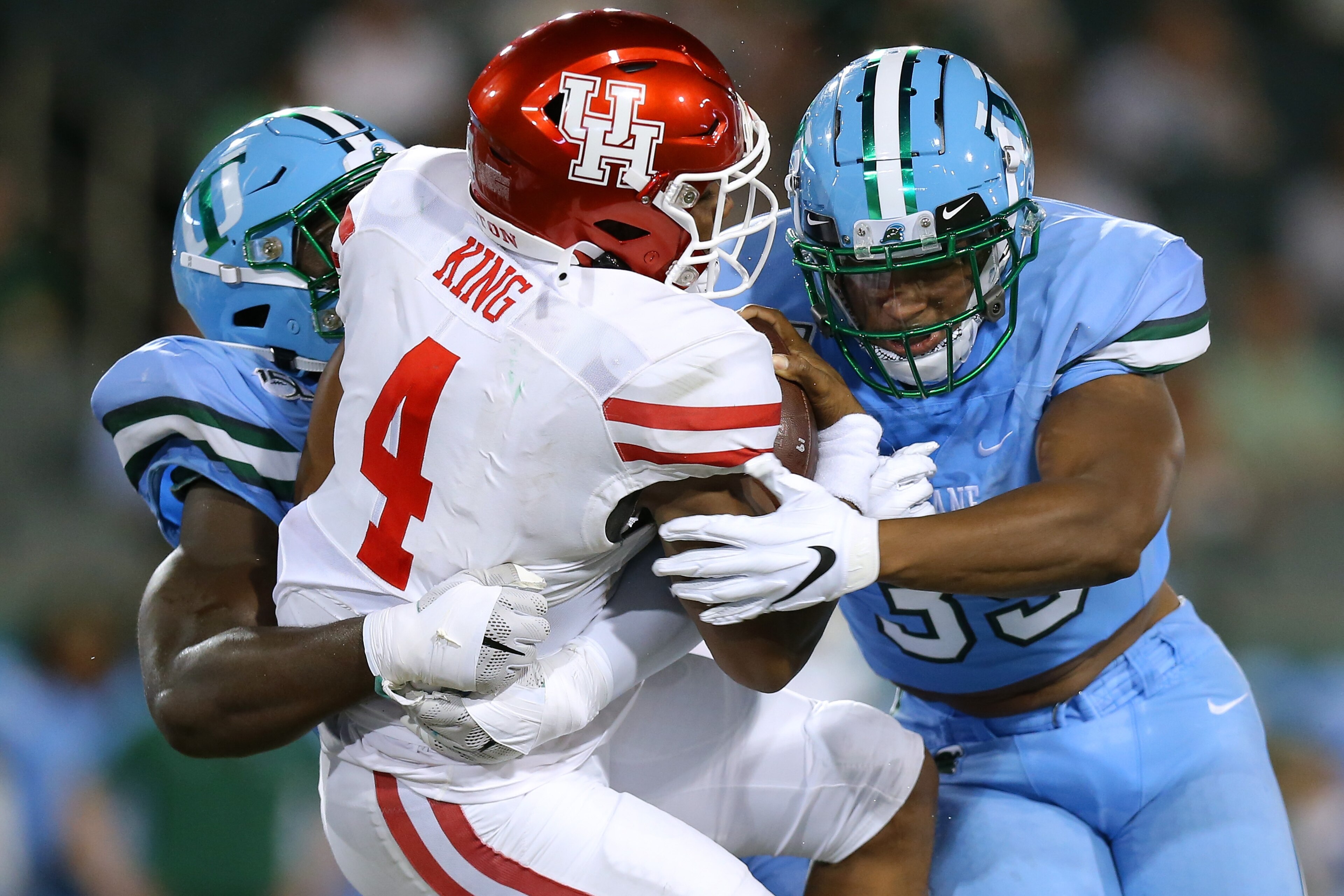NEW ORLEANS, LOUISIANA - SEPTEMBER 19: D'Eriq King #4 of the Houston Cougars is sacked by Cameron Sample #5 of the Tulane Green Wave of the Tulane Green Wave and Lawrence Graham #35 during the first half of a game at Yulman Stadium on September 19, 2019 i