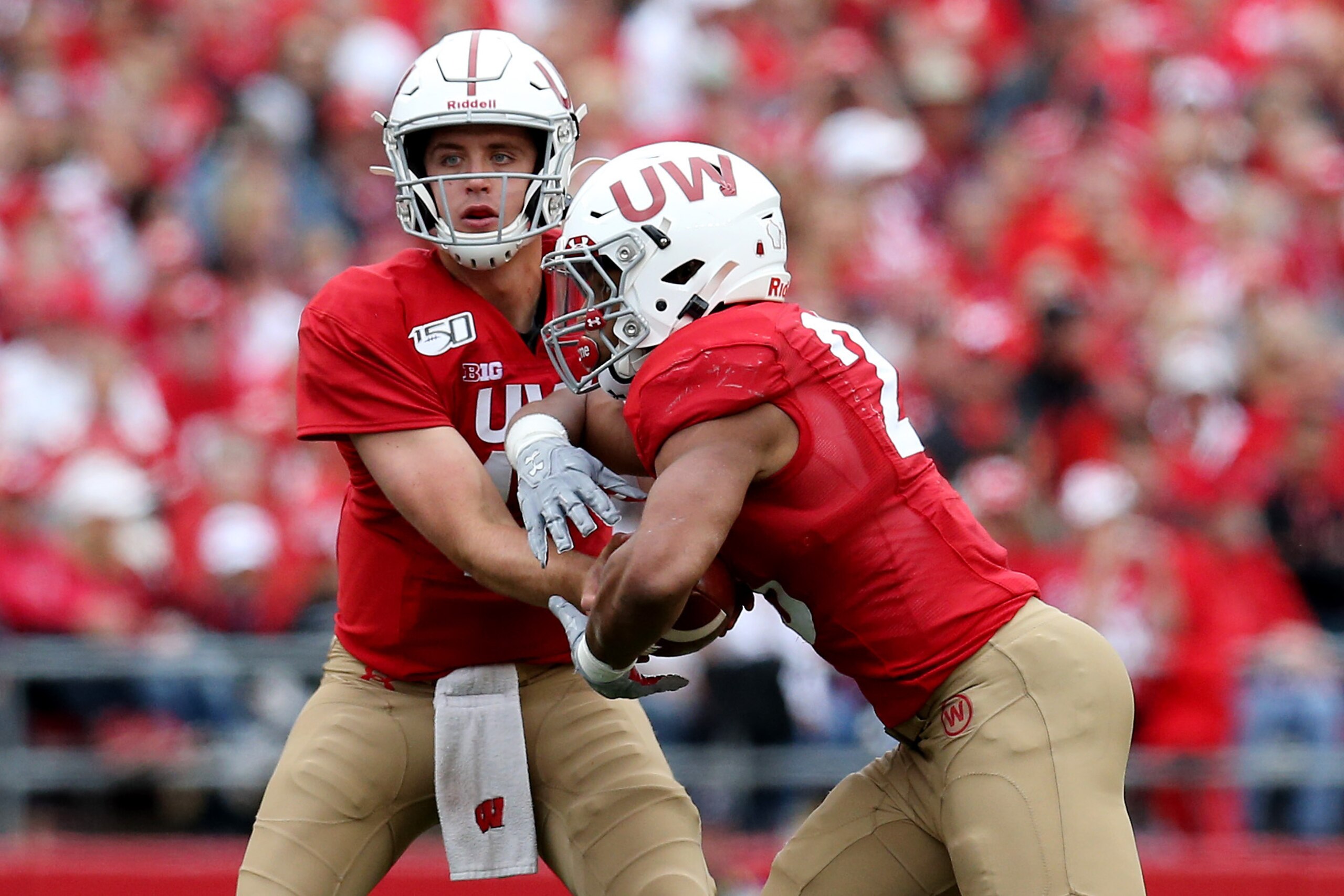 MADISON, WISCONSIN - SEPTEMBER 28:  Jack Coan #17 of the Wisconsin Badgers hands ball off to Jonathan Taylor #23 in the third quarter against the Northwestern Wildcats at Camp Randall Stadium on September 28, 2019 in Madison, Wisconsin. (Photo by Dylan Bu