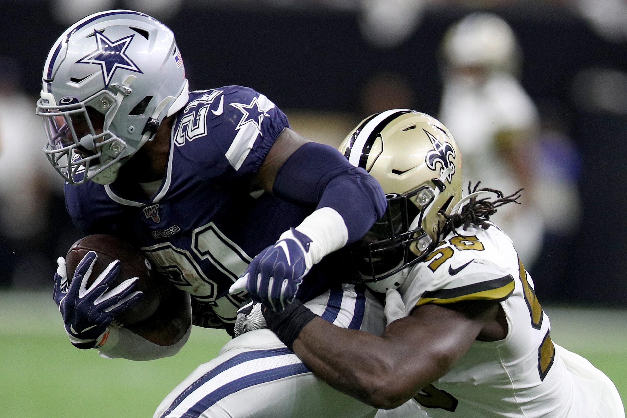 NEW ORLEANS, LOUISIANA - SEPTEMBER 29: Ezekiel Elliott #21 of the Dallas Cowboys runs the ball against Demario Davis #56 of the New Orleans Saints during the second quarter in the game at Mercedes Benz Superdome on September 29, 2019 in New Orleans, Louis