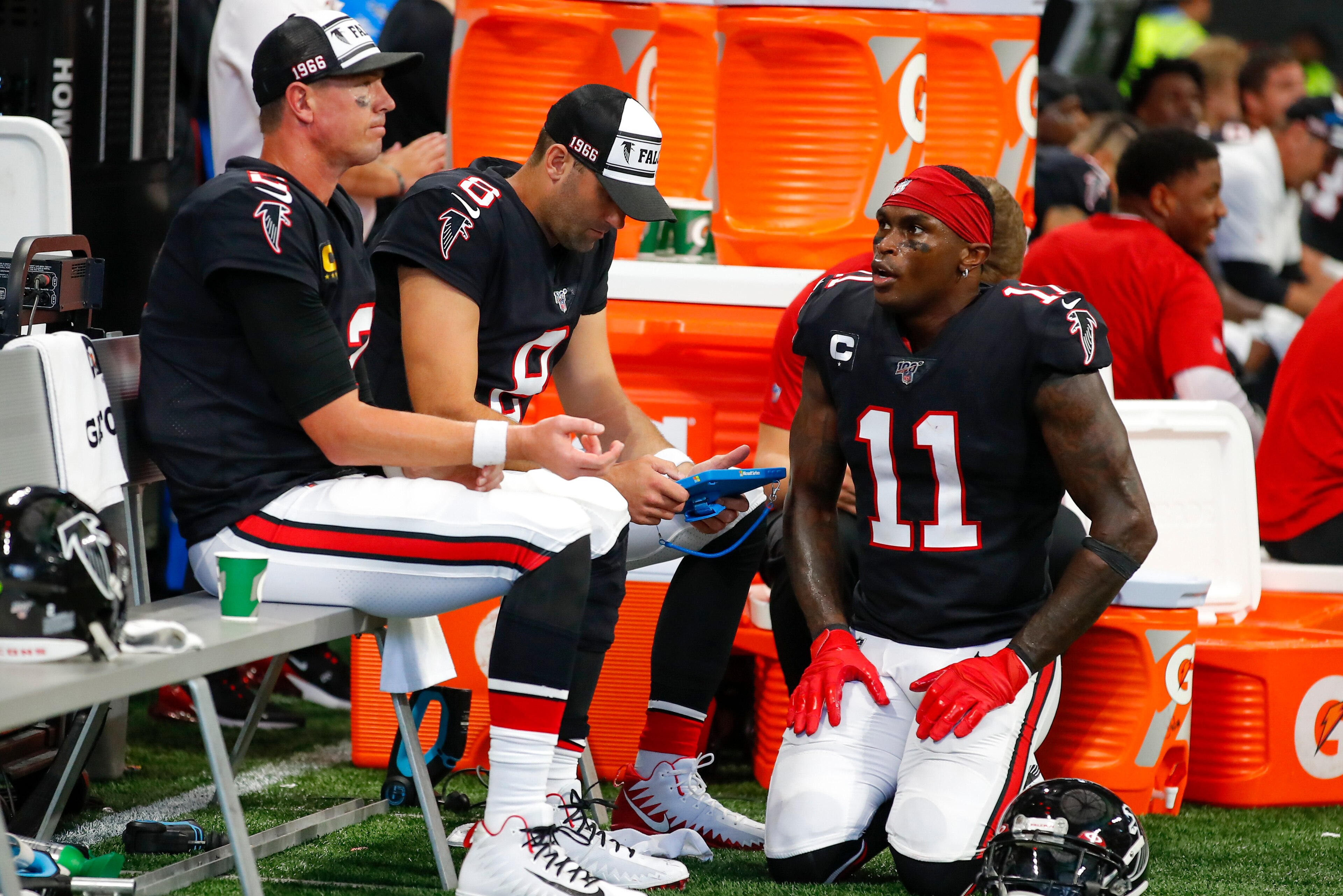 ATLANTA, GA - SEPTEMBER 29: Julio Jones #11 of the Atlanta Falcons speaks with Matt Ryan #2 and Matt Schaub #8 on the sidelines in the second half of an NFL game against the Tennessee Titans at Mercedes-Benz Stadium on September 29, 2019 in Atlanta, Georg ATLANTA, GA - SEPTEMBER 29: Julio Jones #11 of the Atlanta Falcons speaks with Matt Ryan #2 and Matt Schaub #8 on the sidelines in the second half of an NFL game against the Tennessee Titans at Mercedes-Benz Stadium on September 29, 2019 in Atlanta, Georg