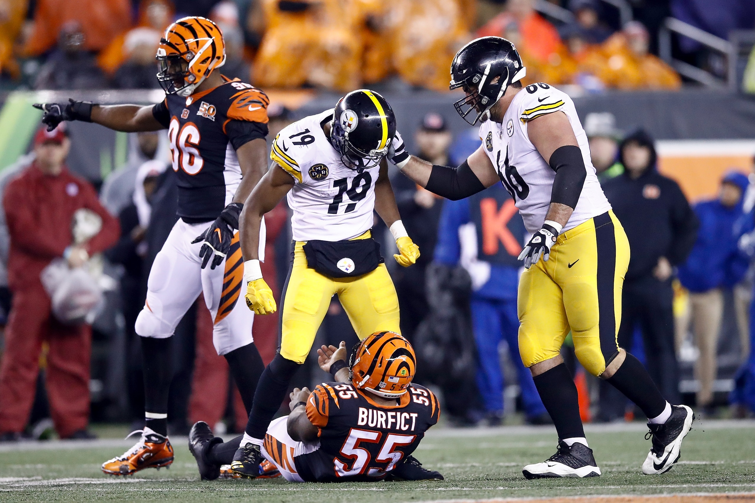 CINCINNATI, OH - DECEMBER 04:  JuJu Smith-Schuster #19 of the Pittsburgh Steelers stands over Vontaze Burfict #55 of the Cincinnati Bengals after a hit during the second half at Paul Brown Stadium on December 4, 2017 in Cincinnati, Ohio.  (Photo by Andy L