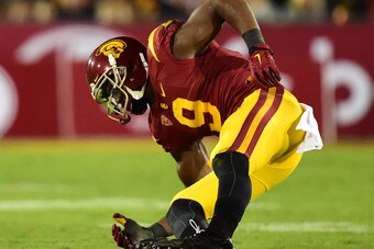 LOS ANGELES, CA - NOVEMBER 07:  JuJu Smith-Schuster #9 of the USC Trojans falls to the ground with an injury during the third quarter against the Arizona Wildcats at Los Angeles Coliseum on November 7, 2015 in Los Angeles, California.  (Photo by Harry How