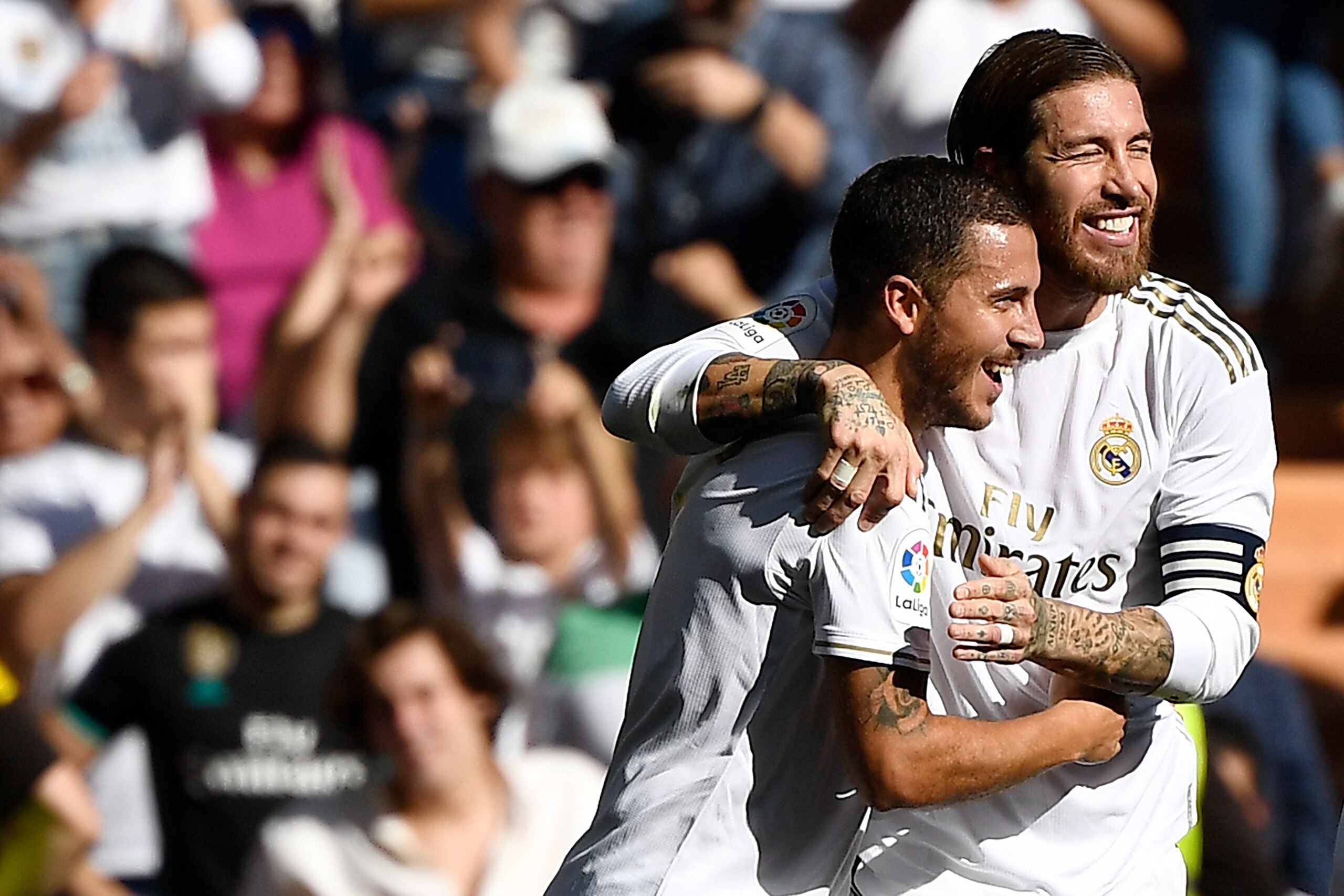 Real Madrid's Belgian forward Eden Hazard (L) celebrates with ramos scoring his team's second goal during the Spanish league football match between Real Madrid CF and Granada FC at the Santiago Bernabeu stadium in Madrid on October 5, 2019. (Photo by PIER Real Madrid's Belgian forward Eden Hazard (L) celebrates with ramos scoring his team's second goal during the Spanish league football match between Real Madrid CF and Granada FC at the Santiago Bernabeu stadium in Madrid on October 5, 2019. (Photo by PIER
