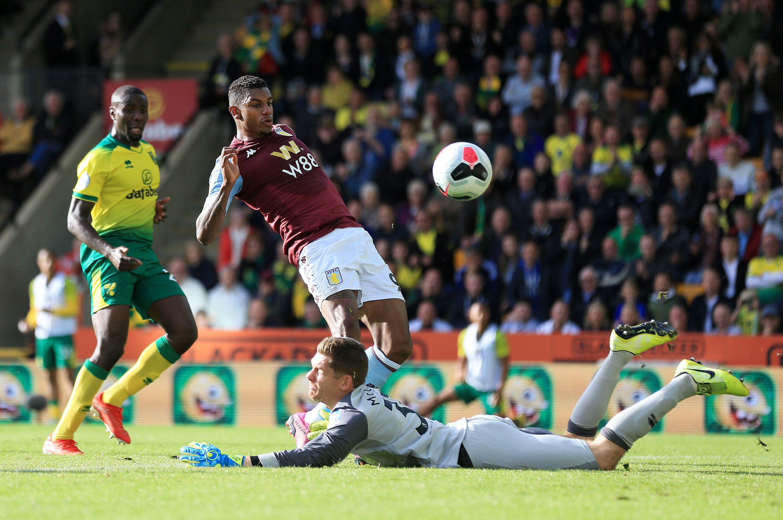 NORWICH, ENGLAND - OCTOBER 05: Wesley of Aston Villa shoots as Michael McGovern of Norwich City attempts to save during the Premier League match between Norwich City and Aston Villa at Carrow Road on October 05, 2019 in Norwich, United Kingdom. (Photo by 