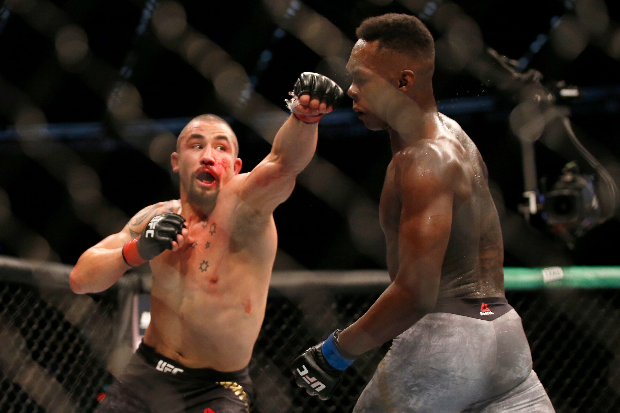 MELBOURNE, AUSTRALIA - OCTOBER 06: Robert Whittaker  and Israel Adesanya fight in the Middleweight title bout during UFC 243 at Marvel Stadium on October 06, 2019 in Melbourne, Australia. (Photo by Darrian Traynor/Getty Images)