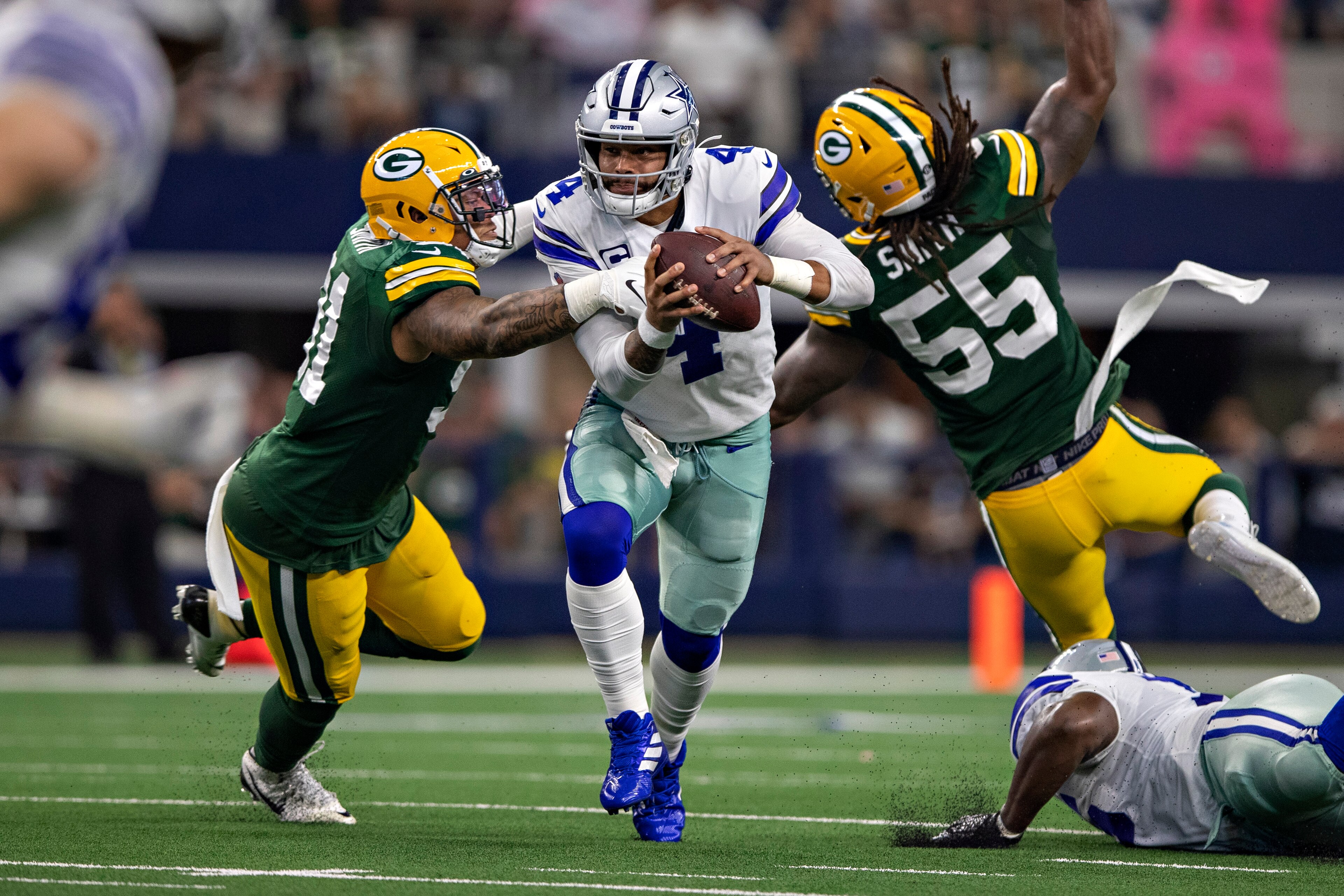 ARLINGTON, TX - OCTOBER 6:  Dak Prescott #4 of the Dallas Cowboys tries to run the ball but is sacked by Preston Smith #91 of the Green Bay Packers at AT&T Stadium on October 6, 2019 in Arlington, Texas.   (Photo by Wesley Hitt/Getty Images)