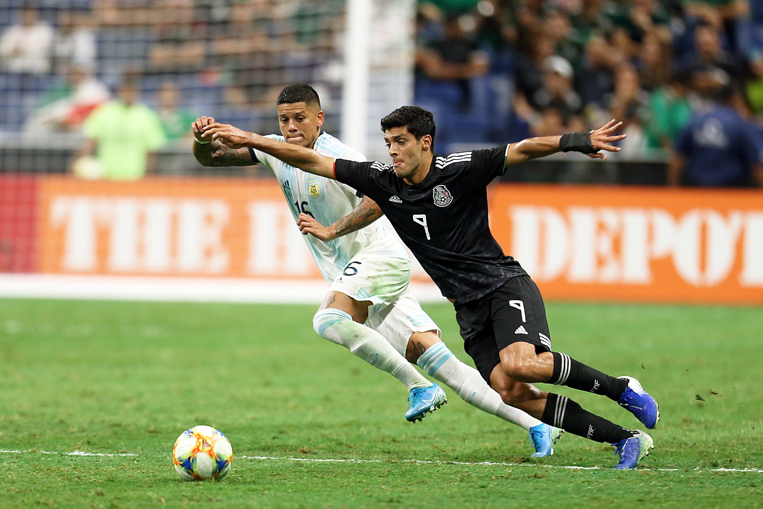 SAN ANTONIO, TX - SEPTEMBER 10: Raul Jimenez #9 of Mexico and Faustino Marcos Rojo #16 of Argentina fight the ball during the international friendly match between Argentina and Mexico at Alamodome on September 10, 2019 in San Antonio, Texas. (Photo by Oma