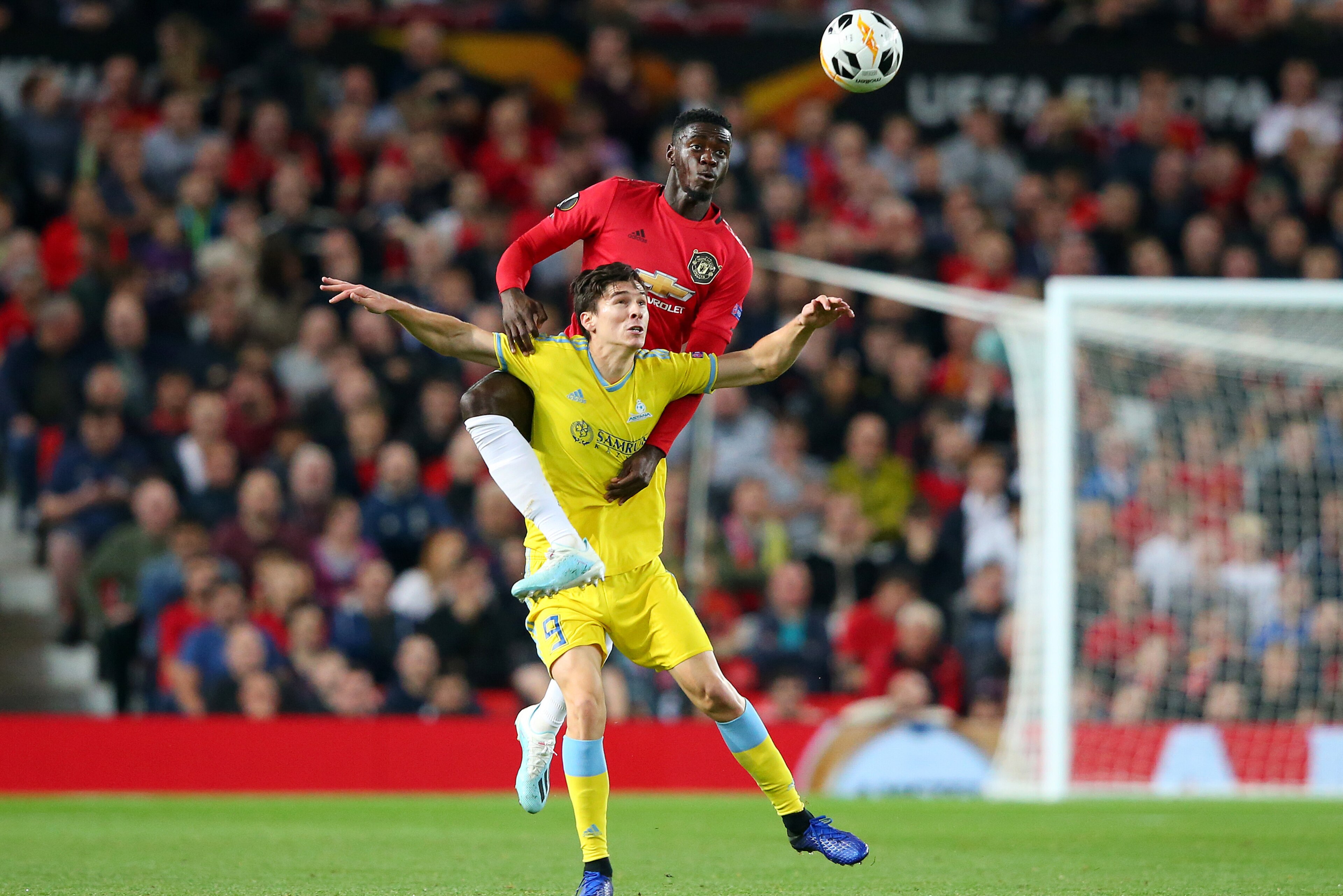 MANCHESTER, ENGLAND - SEPTEMBER 19:  Axel Tuanzebe of Manchester United and Dorin Rotariu of Asanta compete for the ball during the UEFA Europa League group L match between Manchester United and FK Astana at Old Trafford on September 19, 2019 in Mancheste