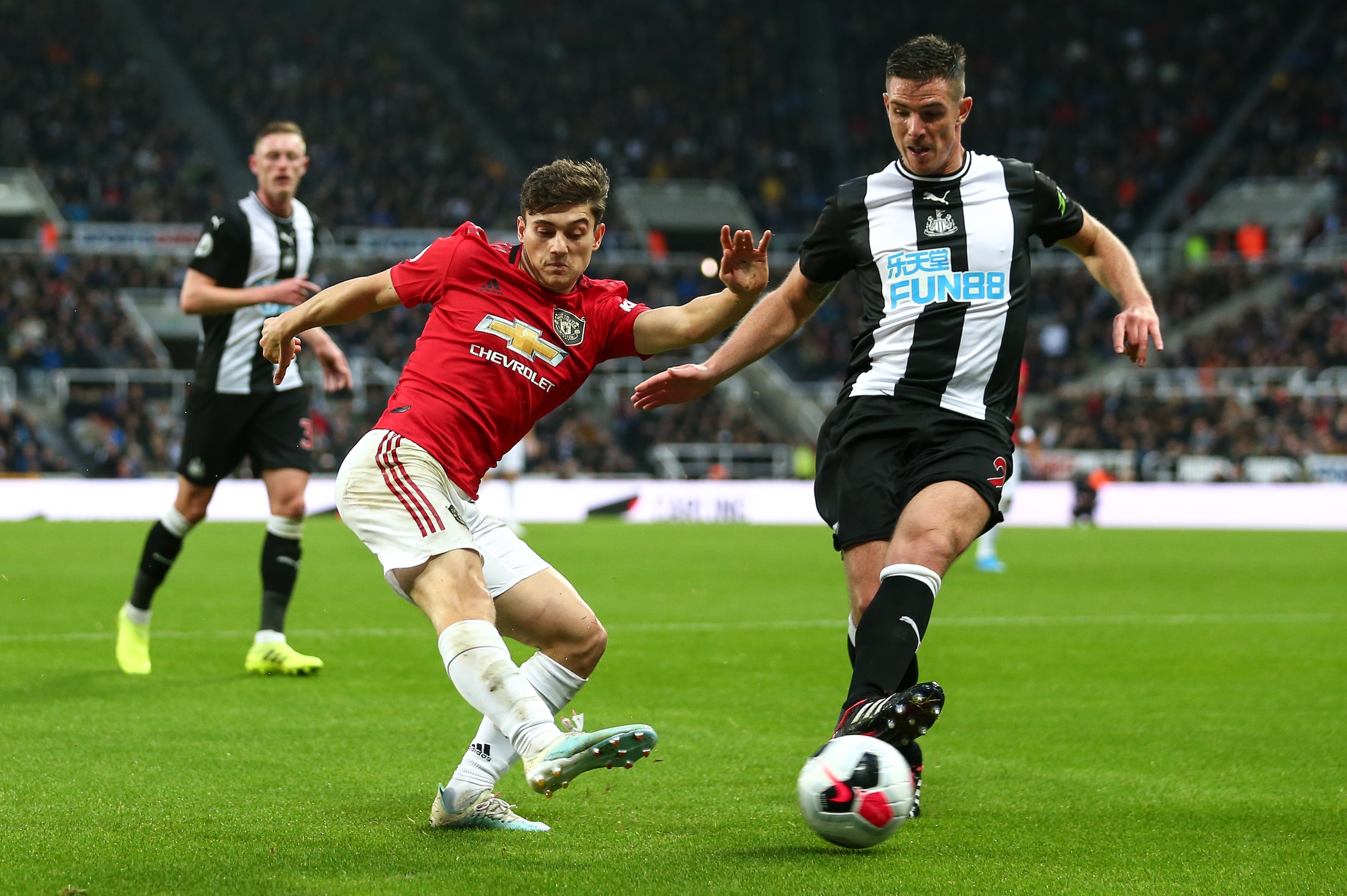 NEWCASTLE UPON TYNE, ENGLAND - OCTOBER 06: Daniel James of Manchester United and Ciaran Clark of Newcastle United during the Premier League match between Newcastle United and Manchester United at St. James Park on October 6, 2019 in Newcastle upon Tyne, U