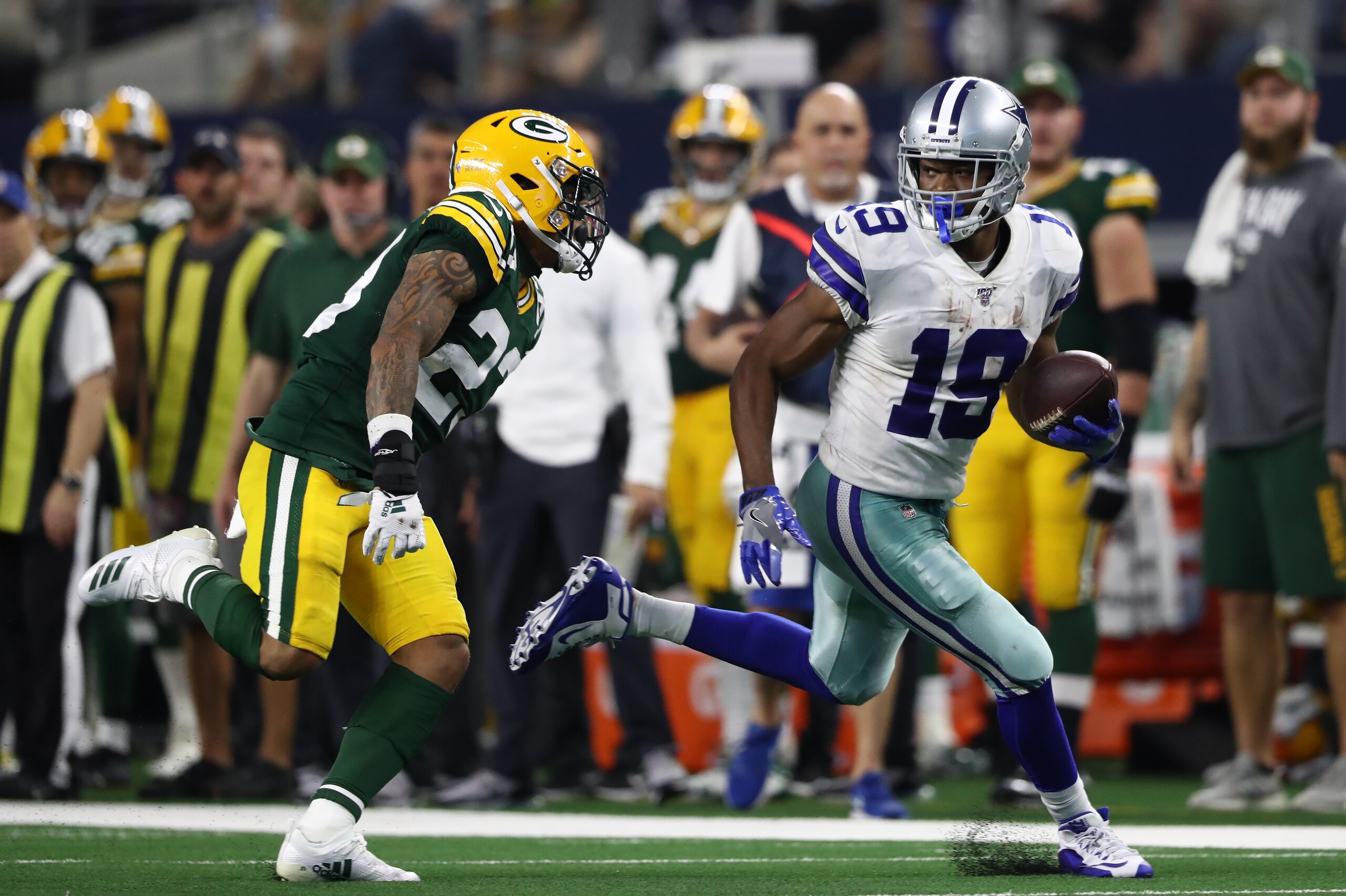 ARLINGTON, TEXAS - OCTOBER 06:  Amari Cooper #19 of the Dallas Cowboys makes a touchdown pass reception against Jaire Alexander #23 of the Green Bay Packers in the fourth quarter at AT&T Stadium on October 06, 2019 in Arlington, Texas. (Photo by Ronald Ma