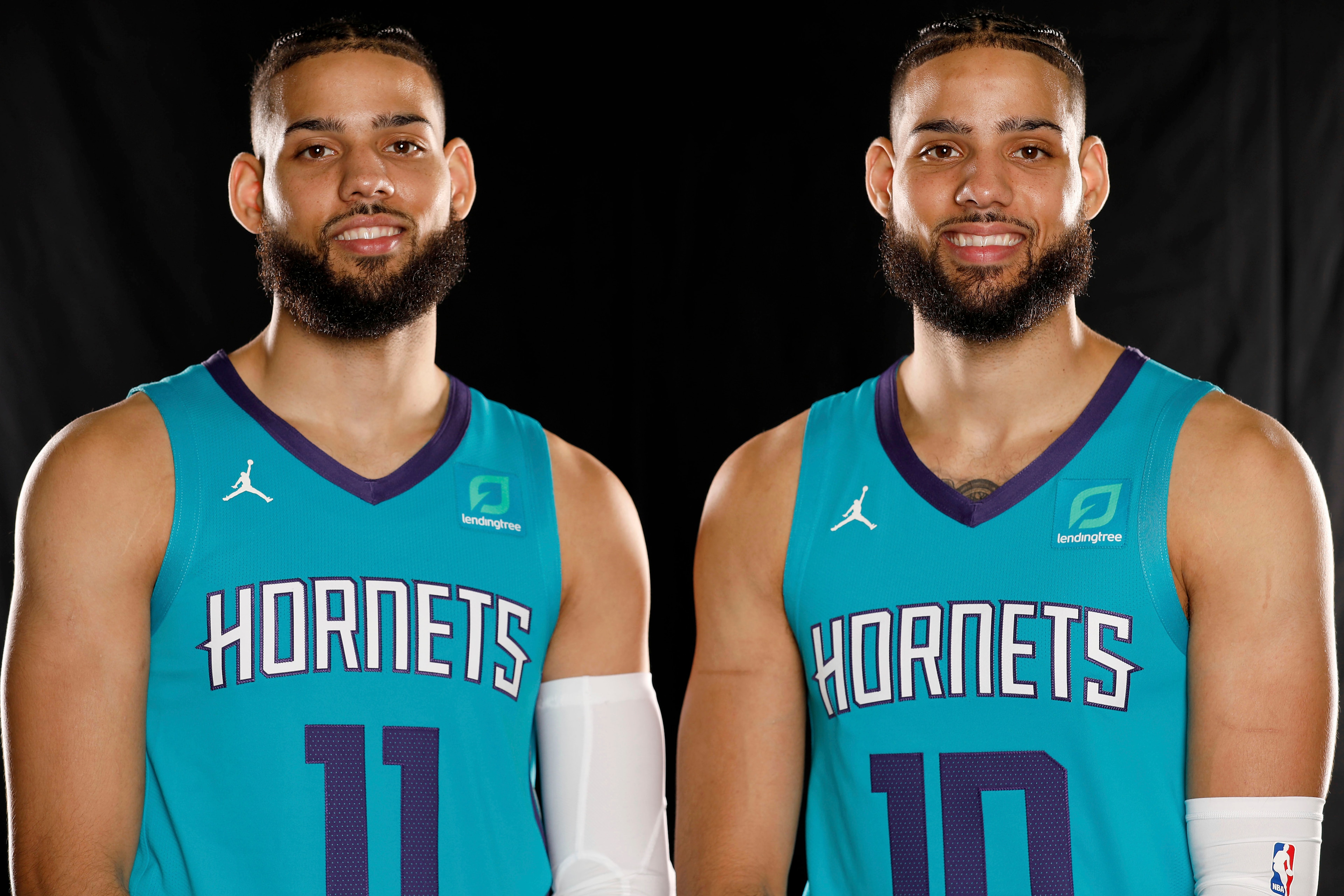 Cody (left) and Caleb Martin (right) suit up for the Charlotte Hornets at 2019 Media Day.