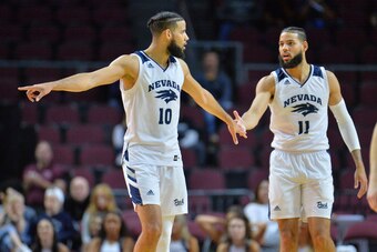 LAS VEGAS, NEVADA - NOVEMBER 22:  Caleb Martin #10 and Cody Martin #11 of the Nevada Wolf Pack stand on the court during their team's game against the Tulsa Golden Hurricane during the 2018 Continental Tire Las Vegas Holiday Invitational basketball tourna