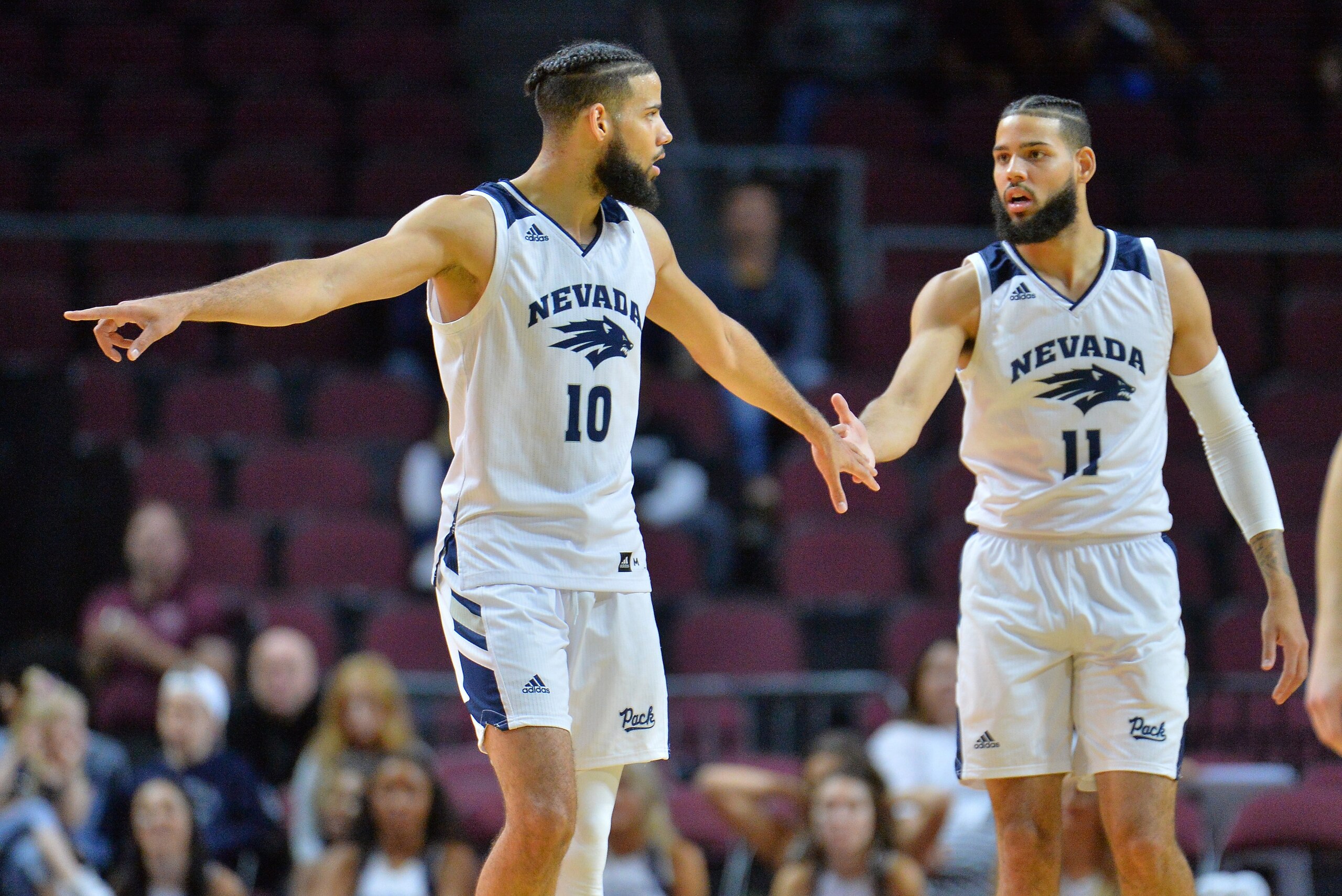 LAS VEGAS, NEVADA - NOVEMBER 22: Caleb Martin #10 and Cody Martin #11 of the Nevada Wolf Pack stand on the court during their team's game against the Tulsa Golden Hurricane during the 2018 Continental Tire Las Vegas Holiday Invitational basketball tourna LAS VEGAS, NEVADA - NOVEMBER 22: Caleb Martin #10 and Cody Martin #11 of the Nevada Wolf Pack stand on the court during their team's game against the Tulsa Golden Hurricane during the 2018 Continental Tire Las Vegas Holiday Invitational basketball tourna