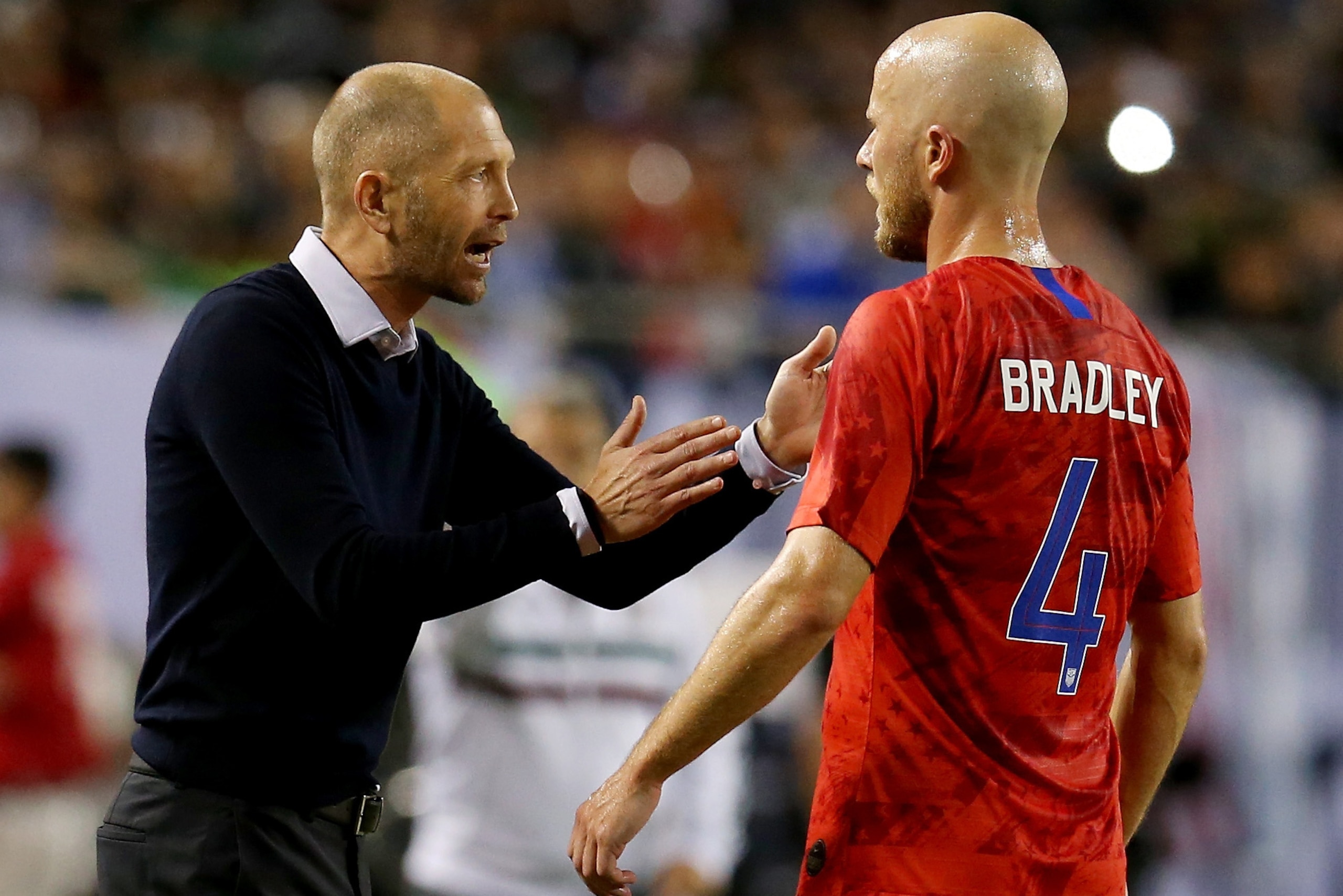 CHICAGO, ILLINOIS - JULY 07:  Head coach Gregg Berhalter of the United States speaks with Michael Bradley #4 in the first half against Mexico during the 2019 CONCACAF Gold Cup Final at Soldier Field on July 07, 2019 in Chicago, Illinois. (Photo by Dylan B