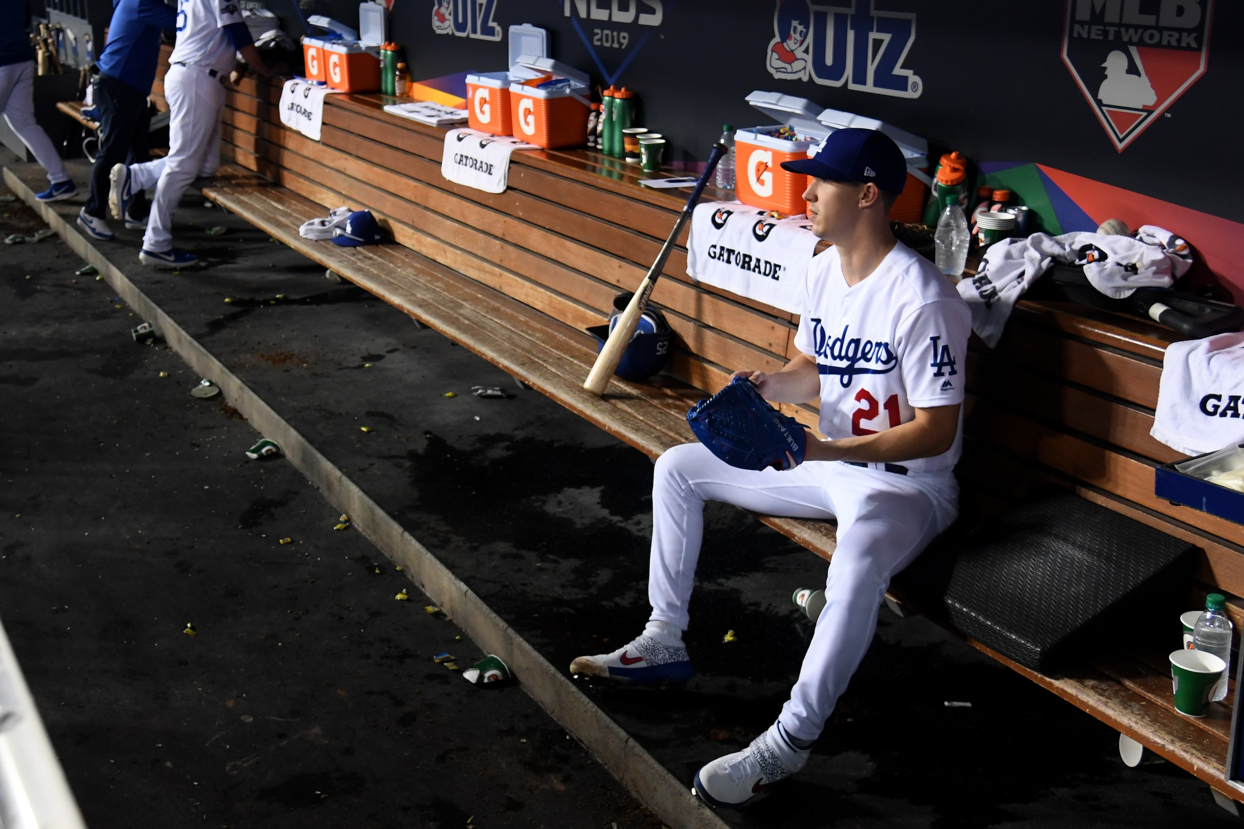 LOS ANGELES, CALIFORNIA - OCTOBER 09: Walker Buehler #21 of the Los Angeles Dodgers sits in the dug out before pitching in the seventh inning of game five of the National League Division Series against the Washington Nationals at Dodger Stadium on October