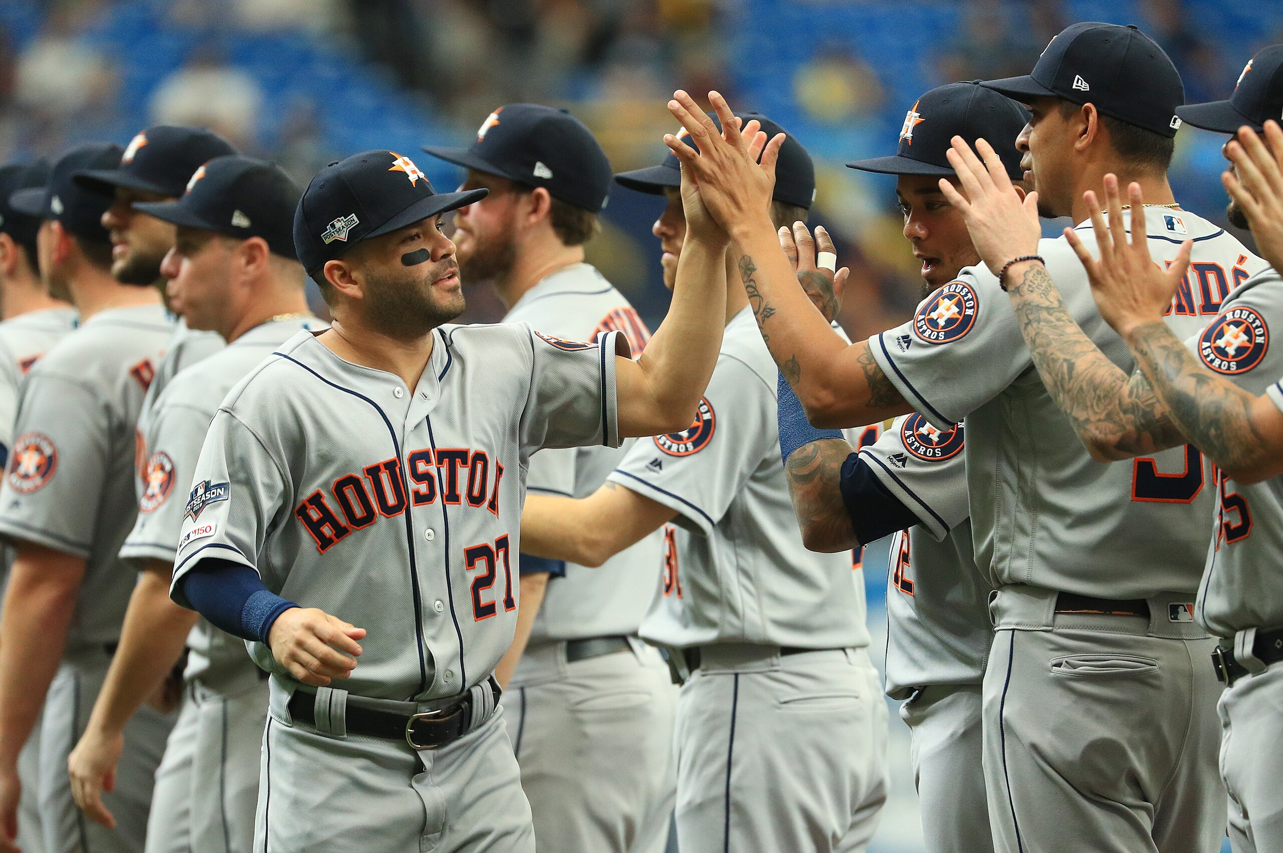 ST PETERSBURG, FLORIDA - OCTOBER 07:  Jose Altuve #27 of the Houston Astros high fives teammates prior to the start of Game Three of the American League Division Series against the Tampa Bay Rays at Tropicana Field on October 07, 2019 in St Petersburg, Fl