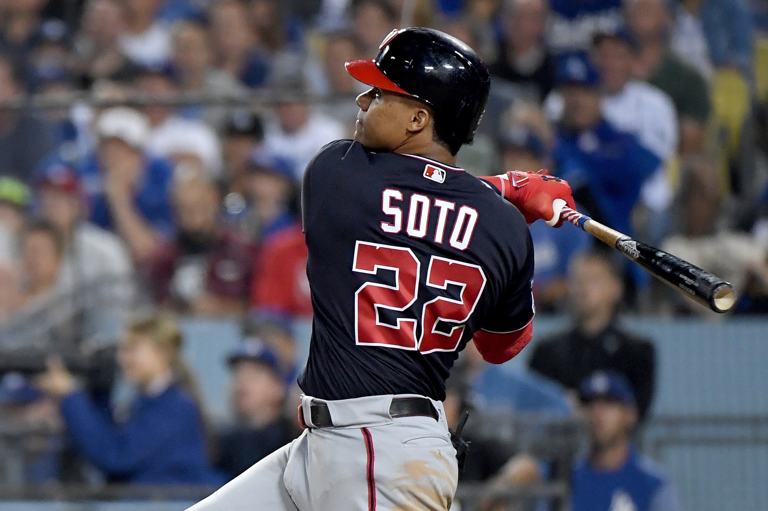 LOS ANGELES, CALIFORNIA - OCTOBER 09:  Juan Soto #22 of the Washington Nationals hits a solo homerun, to tie the game 3-3 with the Los Angeles Dodgers, in the eighth inning of game five of the National League Division Series at Dodger Stadium on October 0