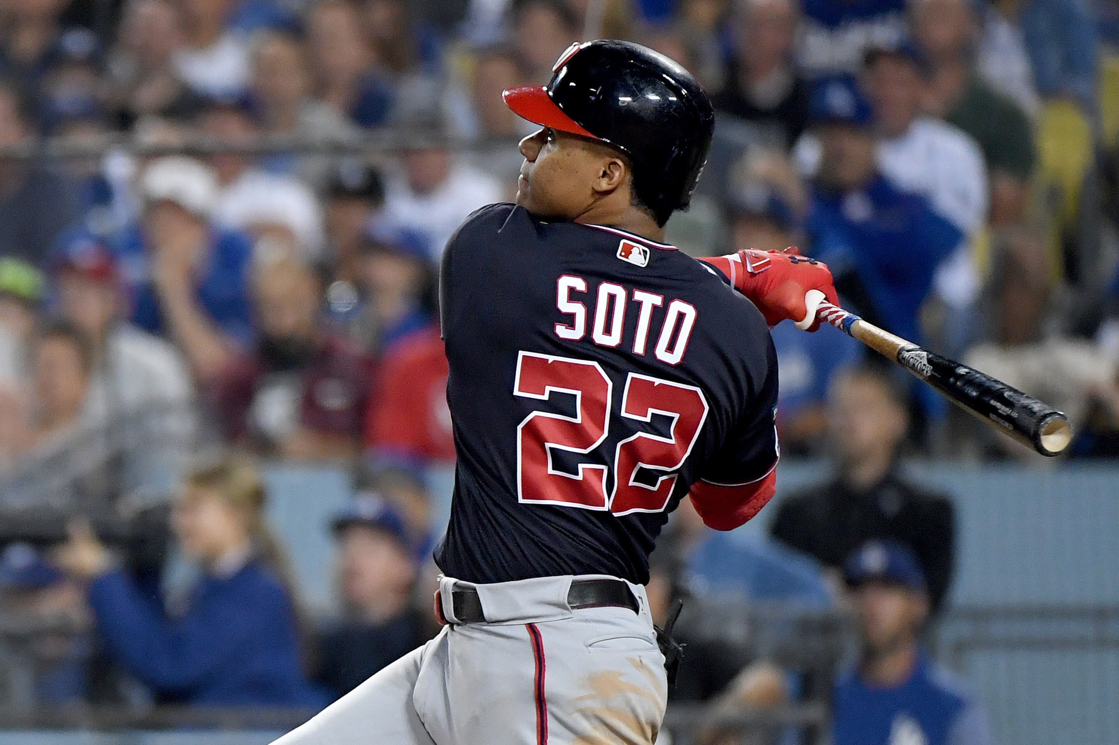 LOS ANGELES, CALIFORNIA - OCTOBER 09:  Juan Soto #22 of the Washington Nationals hits a solo homerun, to tie the game 3-3 with the Los Angeles Dodgers, in the eighth inning of game five of the National League Division Series at Dodger Stadium on October 0
