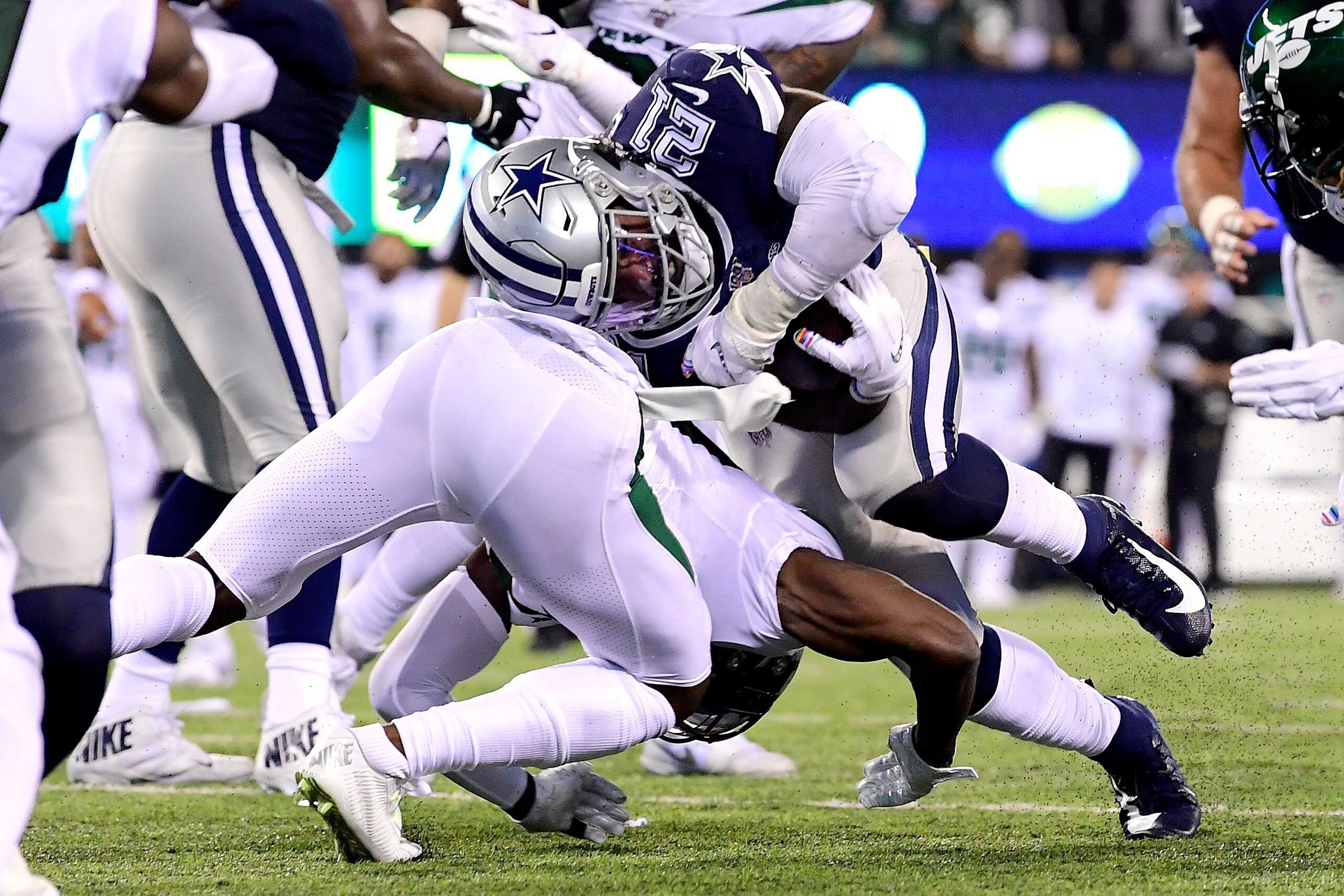 EAST RUTHERFORD, NEW JERSEY - OCTOBER 13:  Ezekiel Elliott #21 of the Dallas Cowboys runs the ball against Marcus Maye #20 of the New York Jets during the fourth quarter at MetLife Stadium on October 13, 2019 in East Rutherford, New Jersey. (Photo by Stev