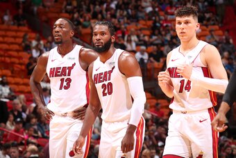 MIAMI, FL - OCTOBER 14: Bam Adebayo #13, Justise Winslow #20, and Tyler Herro #14 of the Miami Heat look on against the Atlanta Hawks during a pre-season game on October 14, 2019 at American Airlines Arena in Miami, Florida. NOTE TO USER: User expressly a