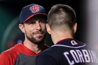 WASHINGTON, DC - AUGUST 16: Max Scherzer #31 of the Washington Nationals speaks with Patrick Corbin #46 in the dugout during the sixth inning against the Milwaukee Brewers at Nationals Park on August 16, 2019 in Washington, DC. (Photo by Scott Taetsch/Get
