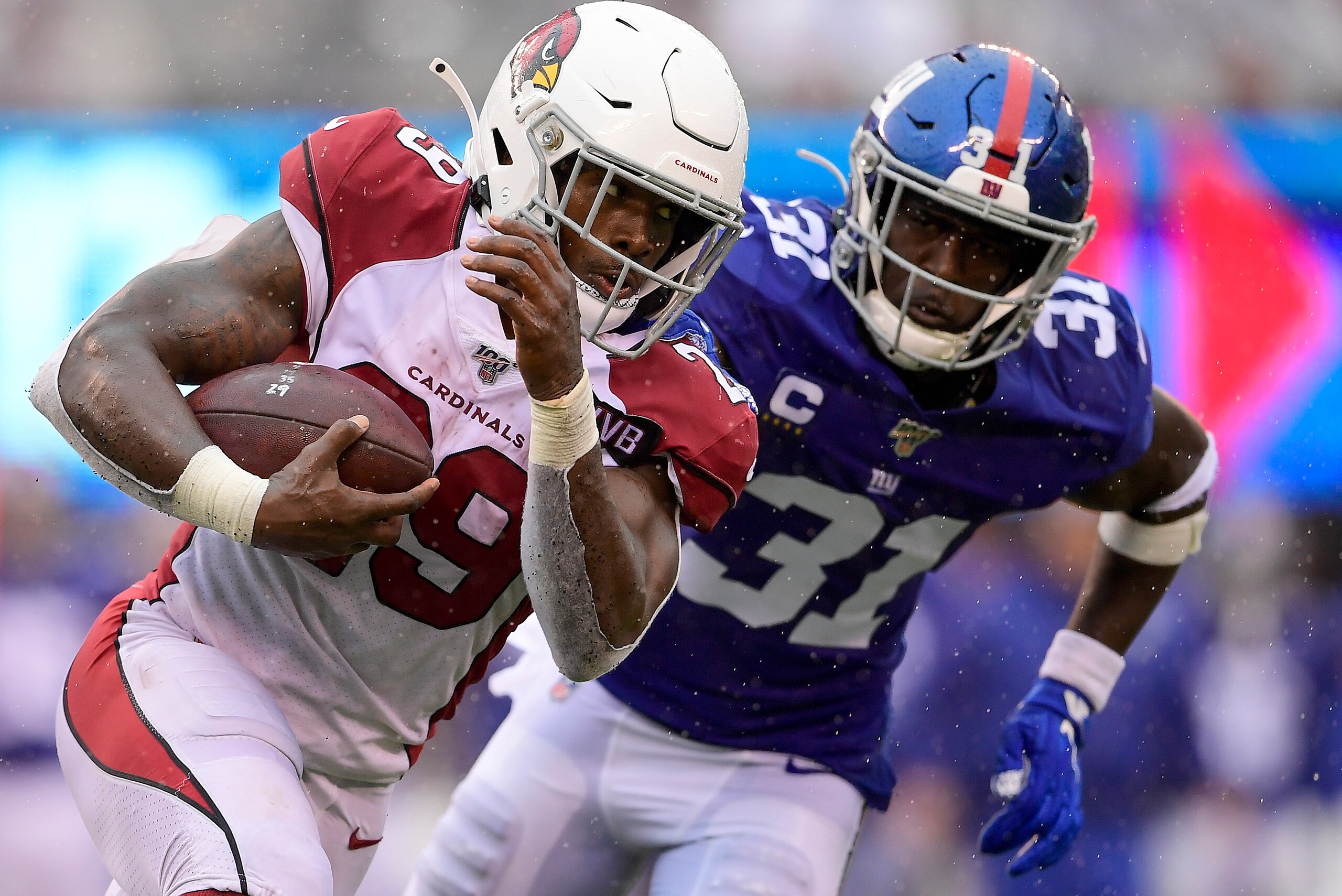 EAST RUTHERFORD, NEW JERSEY - OCTOBER 20:  Chase Edmonds #29 of the Arizona Cardinals runs the ball against Michael Thomas #31 of the New York Giants during the second half at MetLife Stadium on October 20, 2019 in East Rutherford, New Jersey. (Photo by S