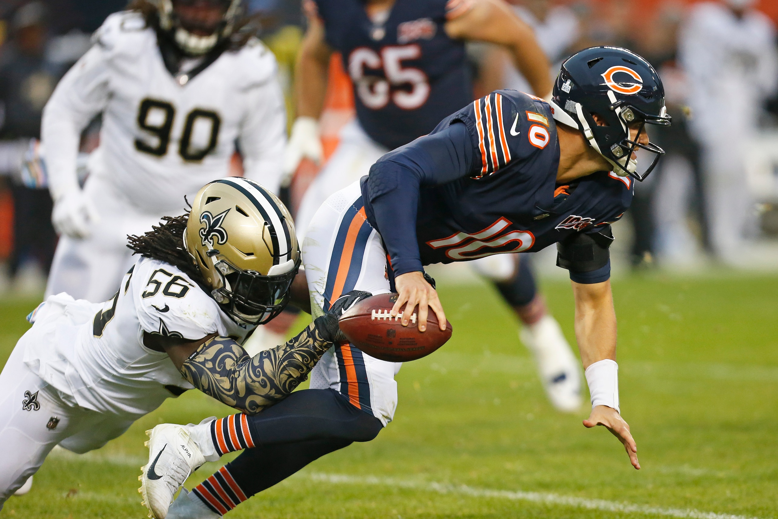 CHICAGO, ILLINOIS - OCTOBER 20: Mitchell Trubisky #10 of the Chicago Bears is brought down by Demario Davis #56 of the New Orleans Saints during the second half at Soldier Field on October 20, 2019 in Chicago, Illinois. (Photo by Nuccio DiNuzzo/Getty Imag