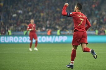 TOPSHOT - Portugal's forward Cristiano Ronaldo celebrates after scoring a goal from the penalty spot during the Euro 2020 football qualification match between Ukraine and Portugal at the NSK Olimpiyskyi stadium in Kiev on October 14, 2019. (Photo by Genya