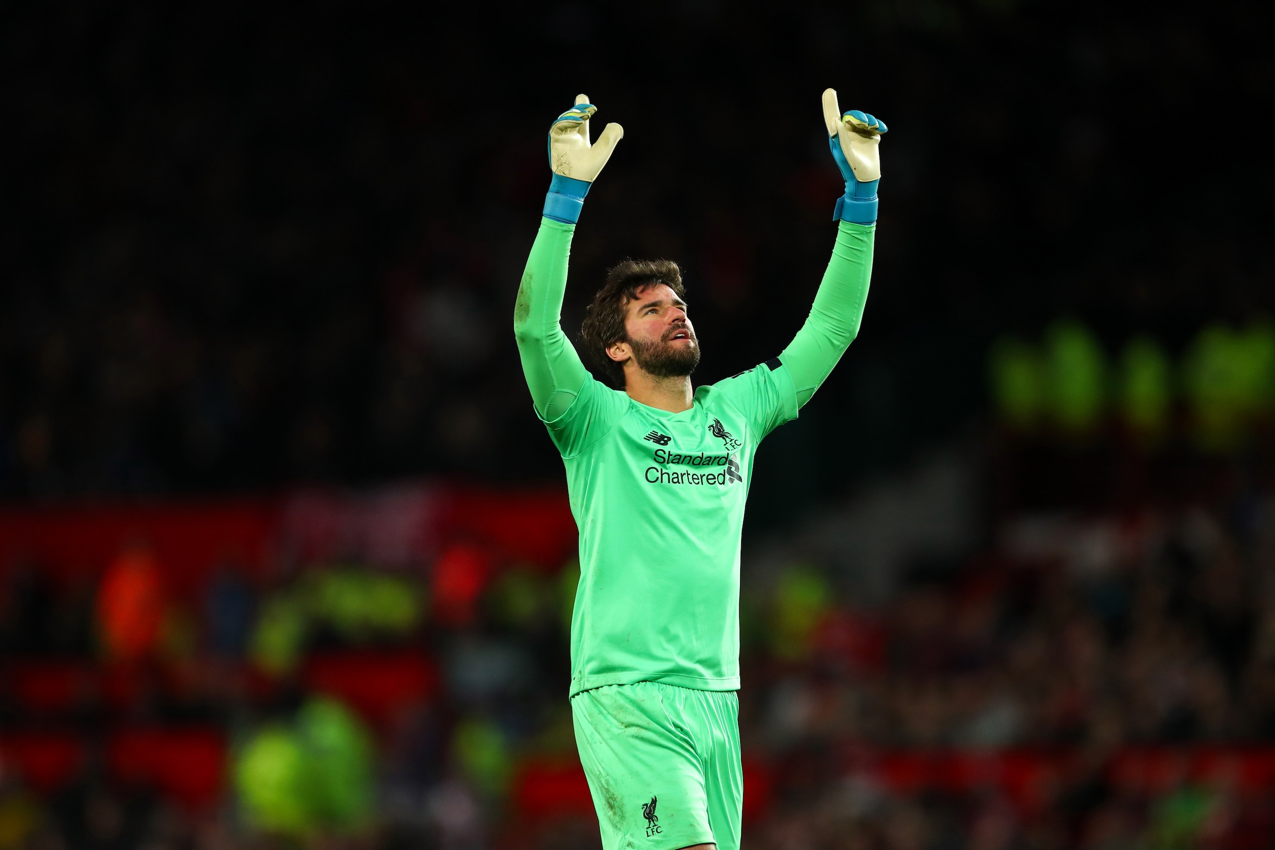 MANCHESTER, ENGLAND - OCTOBER 20: Alisson of Liverpool celebrates after Adam Lallana of Liverpool scored a goal to make it 1-1 during the Premier League match between Manchester United and Liverpool FC at Old Trafford on October 20, 2019 in Manchester, Un
