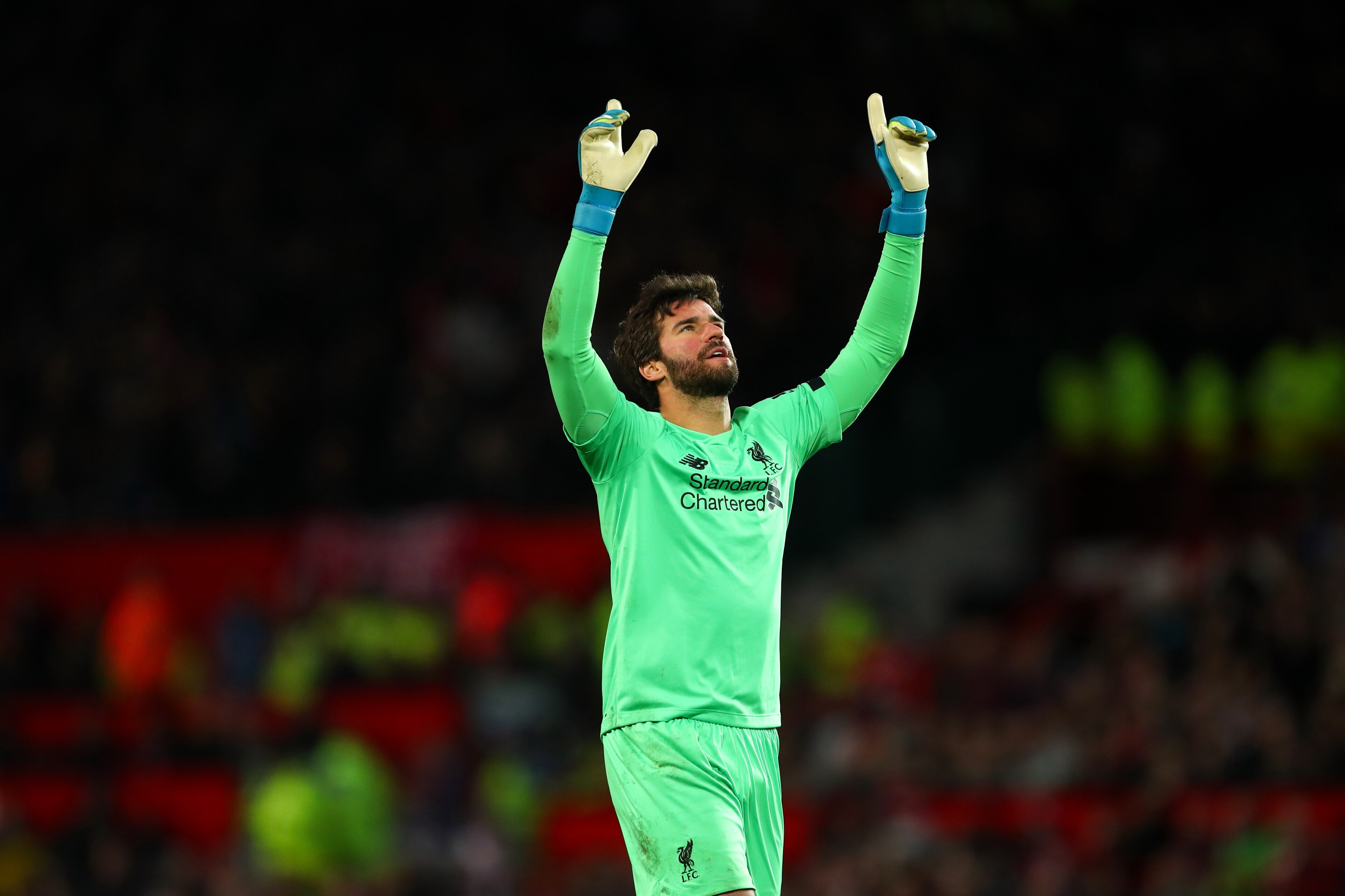 MANCHESTER, ENGLAND - OCTOBER 20: Alisson of Liverpool celebrates after Adam Lallana of Liverpool scored a goal to make it 1-1 during the Premier League match between Manchester United and Liverpool FC at Old Trafford on October 20, 2019 in Manchester, Un