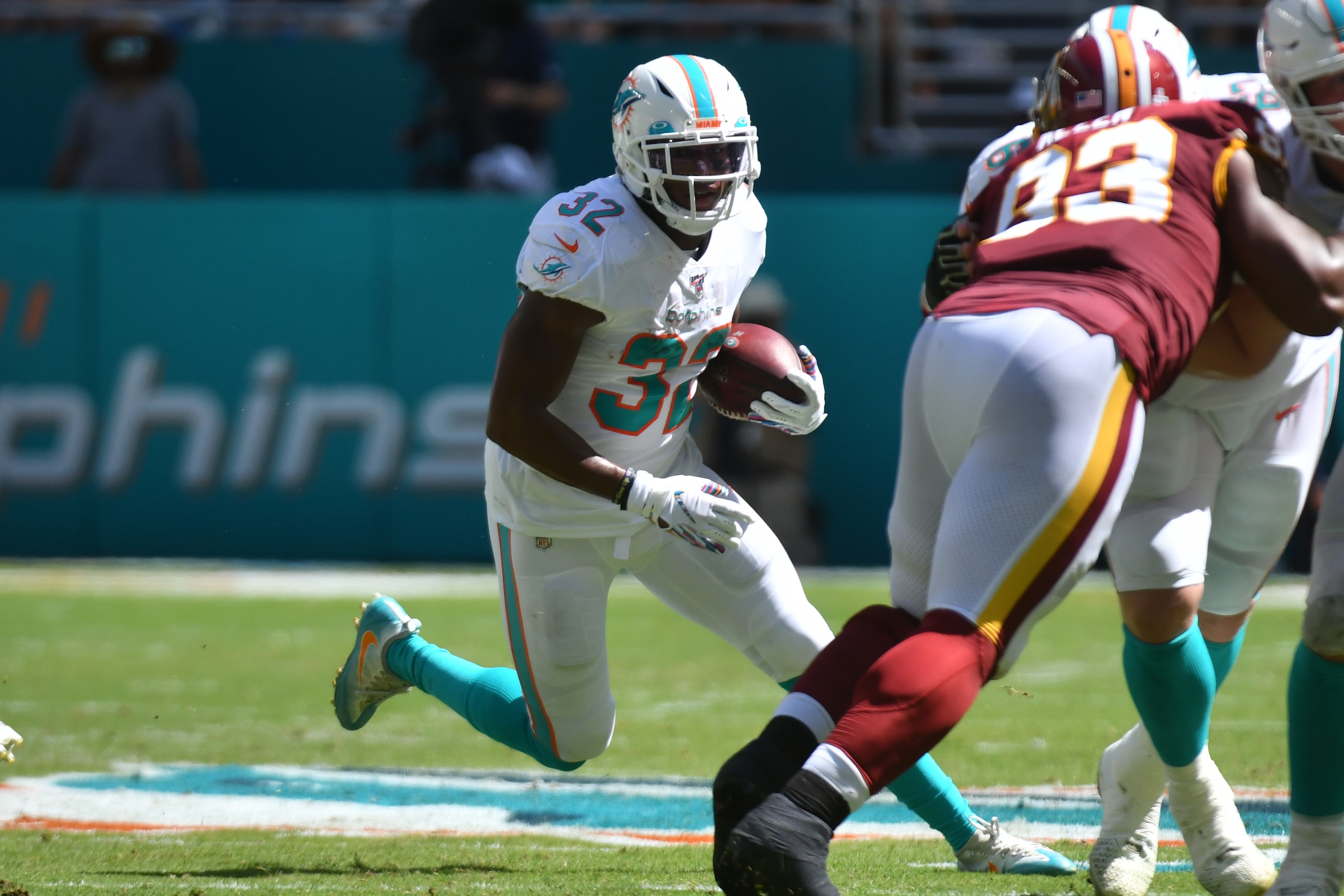 MIAMI, FL - OCTOBER 13: Kenyan Drake #32 of the Miami Dolphins rushes the football during the first half against the Washington Redskins at Hard Rock Stadium on October 13, 2019 in Miami, Florida. (Photo by Eric Espada/Getty Images)