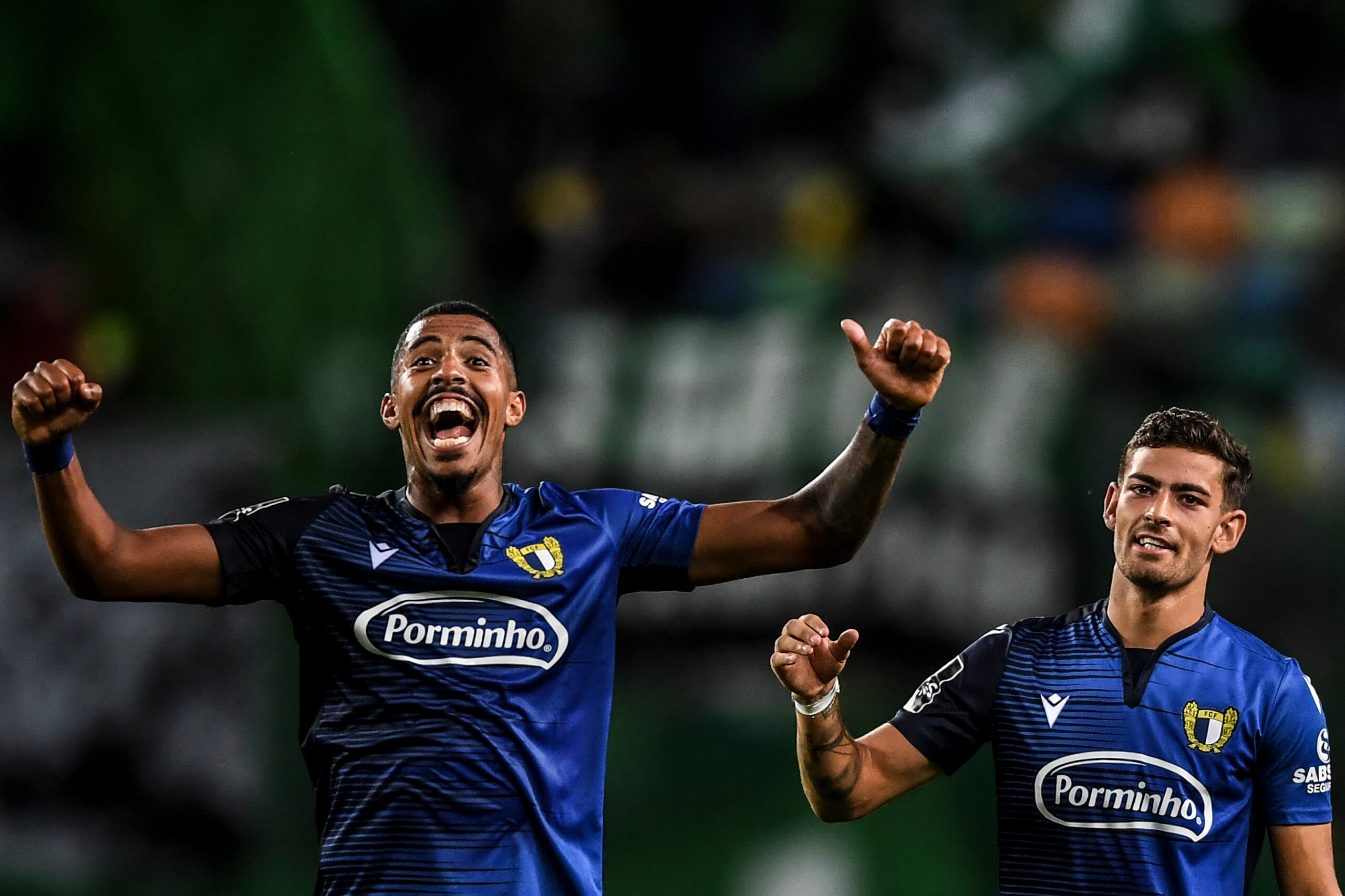 Famalicao's Brazilian forward Anderson Oliveira (L) and Famalicao's Portuguese forward Ruben Lameiras (R) celebrate their victory at the end of the Portuguese league football match between Sporting CP and FC Famalicao at the Jose Alvalade stadium in Lisbo