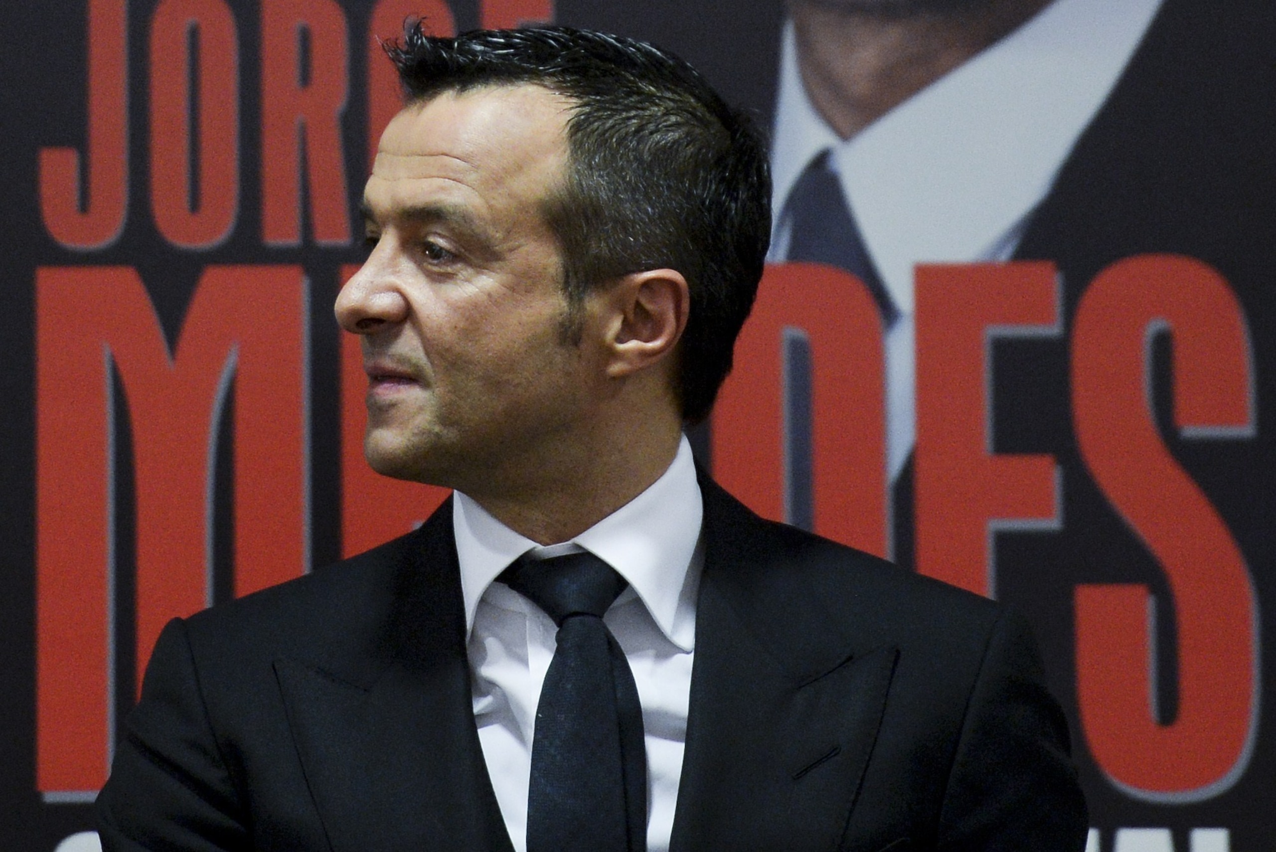 Portuguese football manager Jorge Mendes stand in front of the book