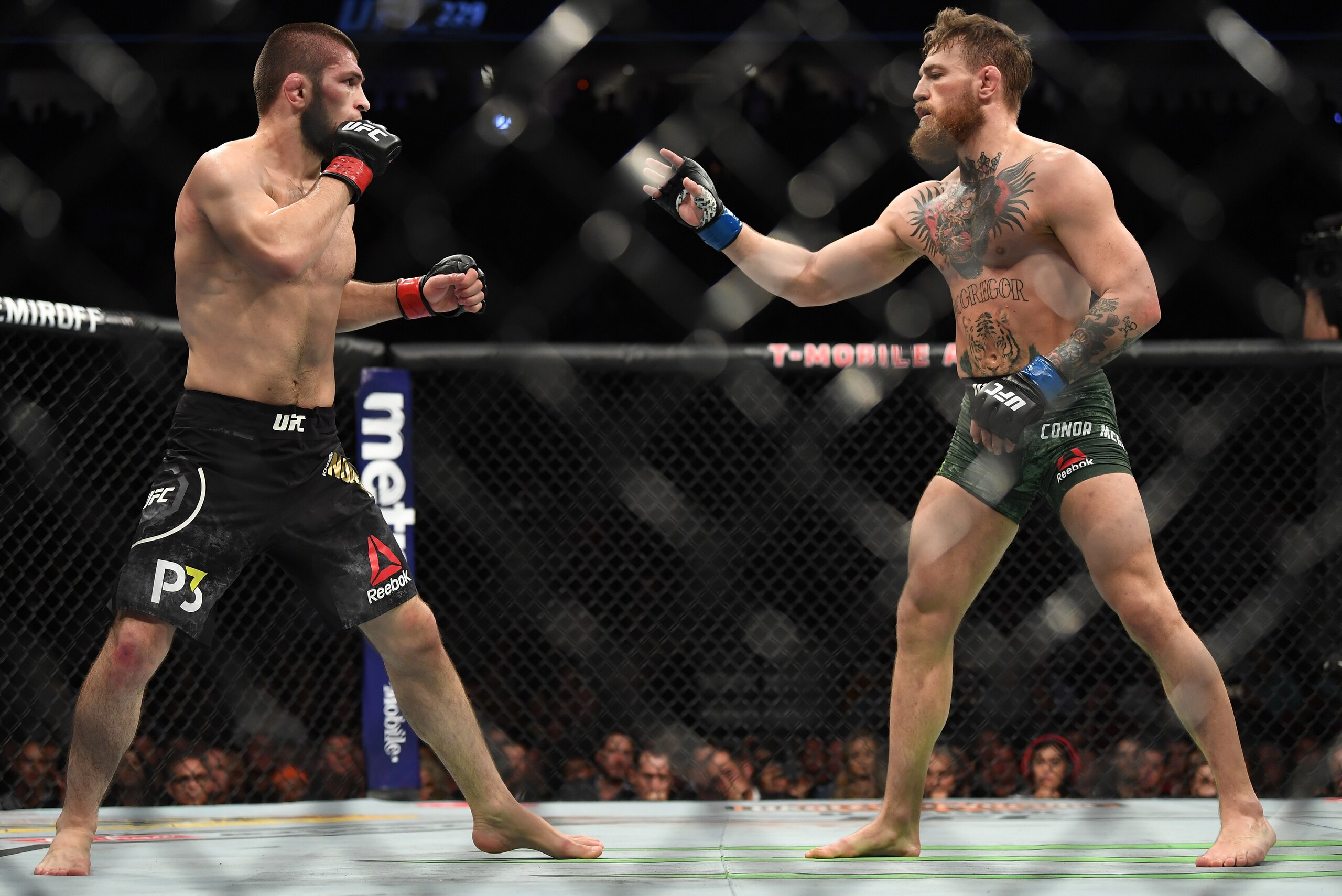 LAS VEGAS, NV - OCTOBER 06:  (L-R) Khabib Nurmagomedov of Russia faces Conor McGregor of Ireland in their UFC lightweight championship bout during the UFC 229 event inside T-Mobile Arena on October 6, 2018 in Las Vegas, Nevada. (Photo by Jeff Bottari/Zuff