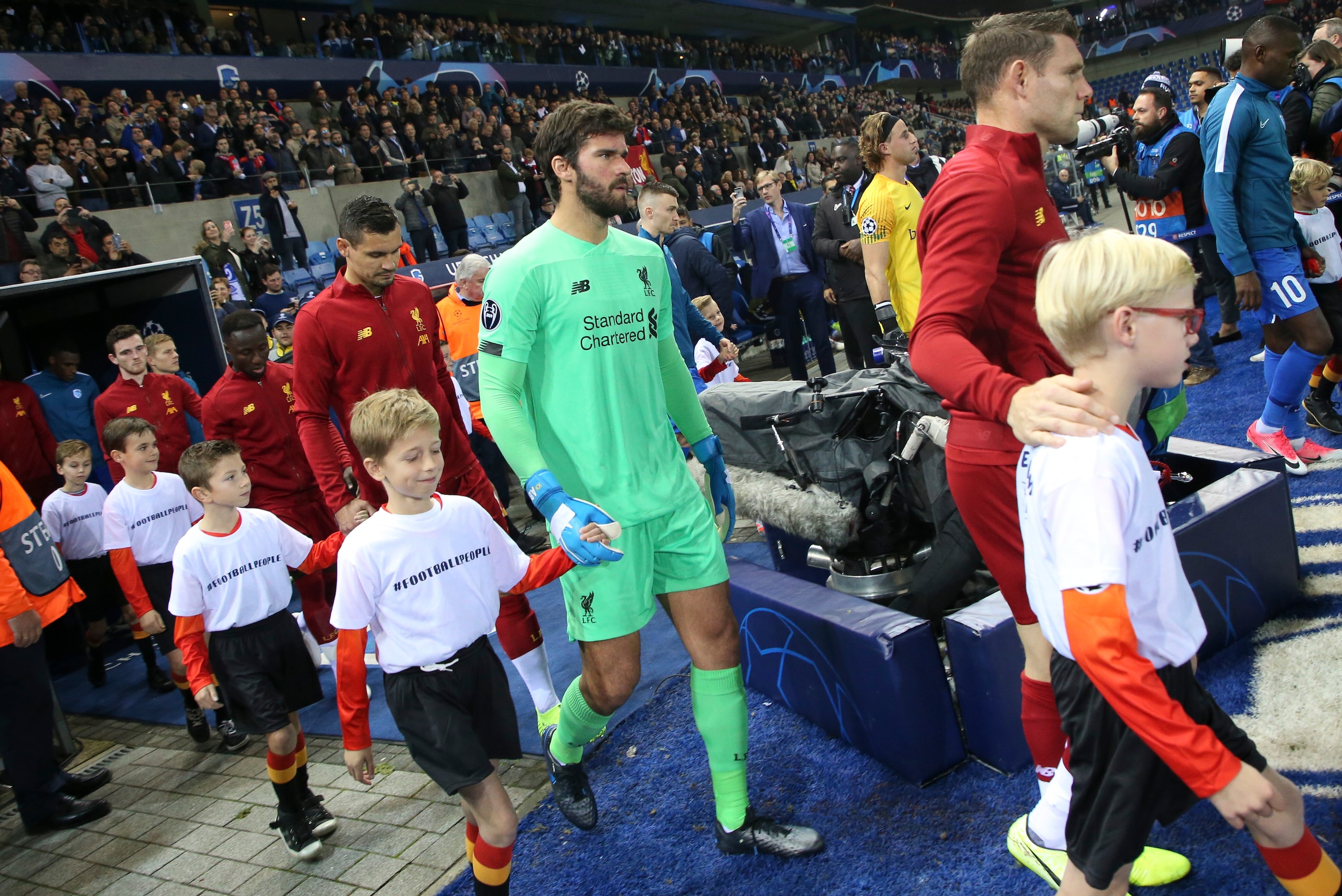 GENK, BELGIUM - OCTOBER 23: James Milner, goalkeeper Alisson Becker and players of Liverpool enter the pitch prior to the UEFA Champions League group E match between KRC Genk and Liverpool FC at Luminus Arena on October 23, 2019 in Genk, Belgium. (Photo b