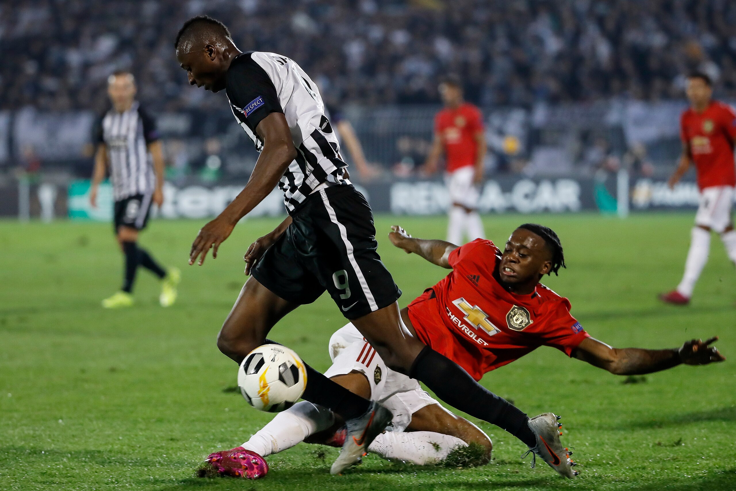 BELGRADE, SERBIA - OCTOBER 24: Umar Sadiq (L) of Partizan is challenged by Aaron Wan-Bissaka (R) of Manchester United during the UEFA Europa League group L match between Partizan and Manchester United at Partizan Stadium on October 24, 2019 in Belgrade, S