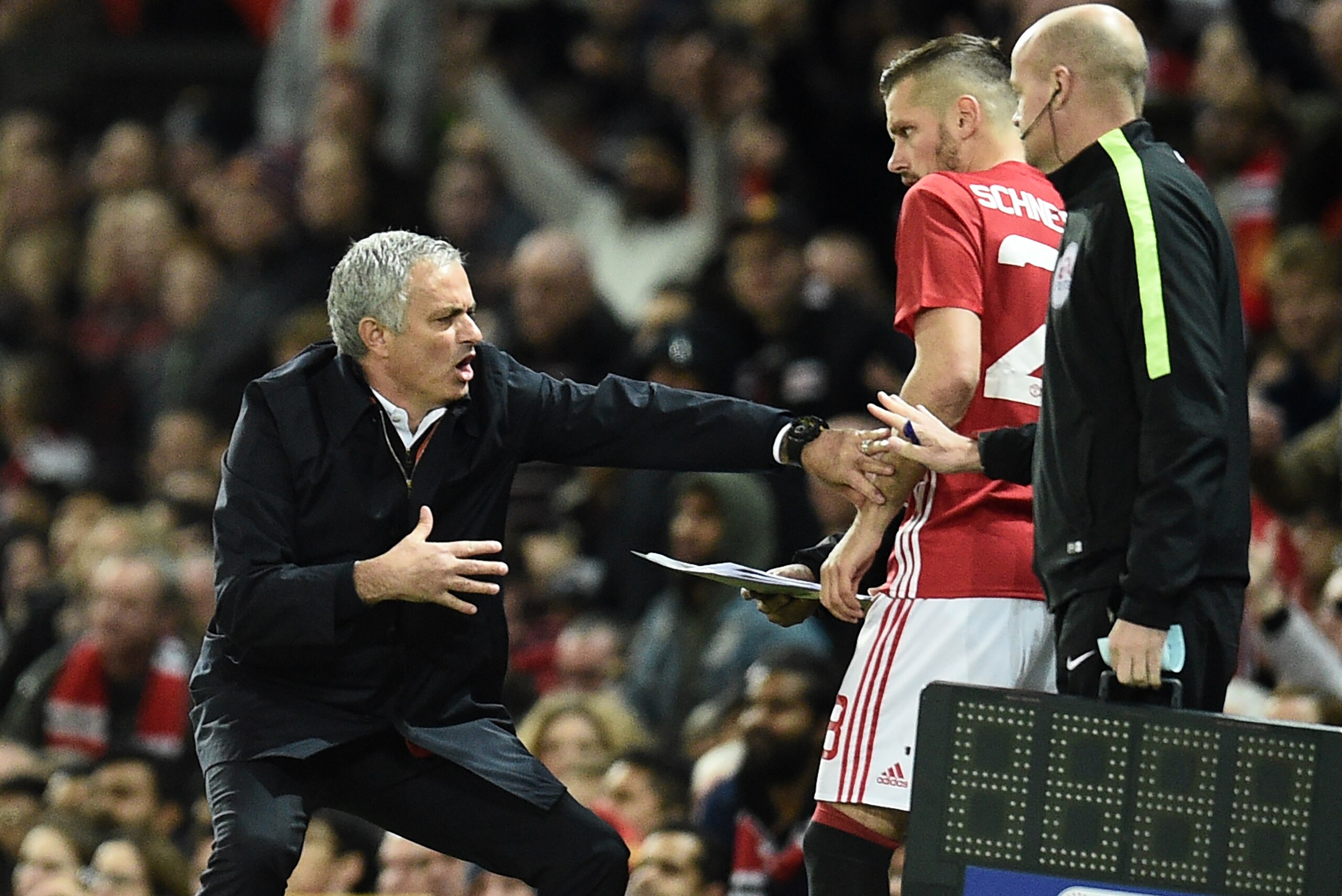 Manchester United's Portuguese manager Jose Mourinho gestures as Manchester United's French midfielder Morgan Schneiderlin prepares to come on as substitute during the EFL (English Football League) Cup fourth round match between Manchester United and Manc