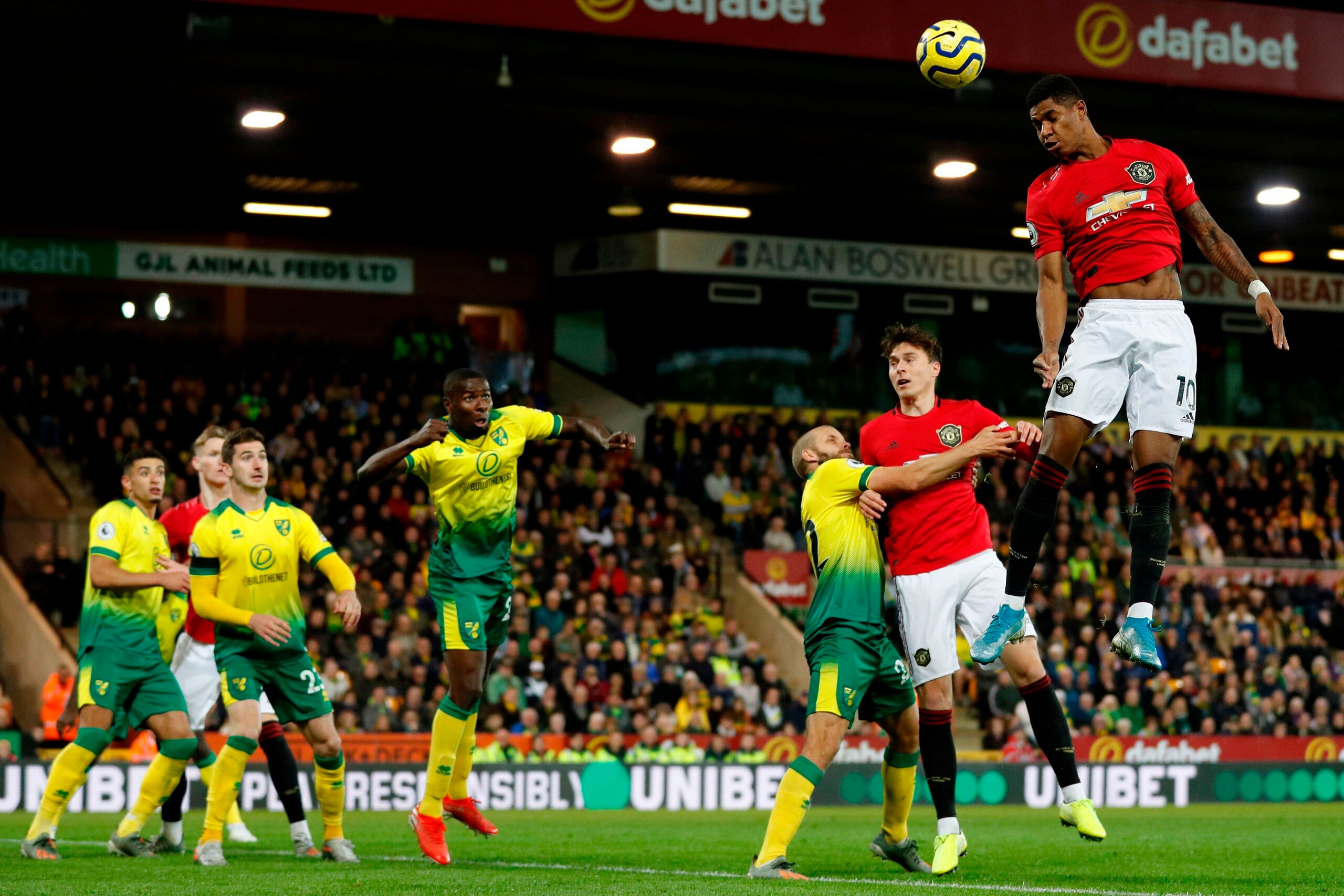 Manchester United's English striker Marcus Rashford (R) jumps to win a header during the English Premier League football match between Norwich City and Manchester United at Carrow Road in Norwich, eastern England on October 27, 2019. (Photo by Adrian DENN