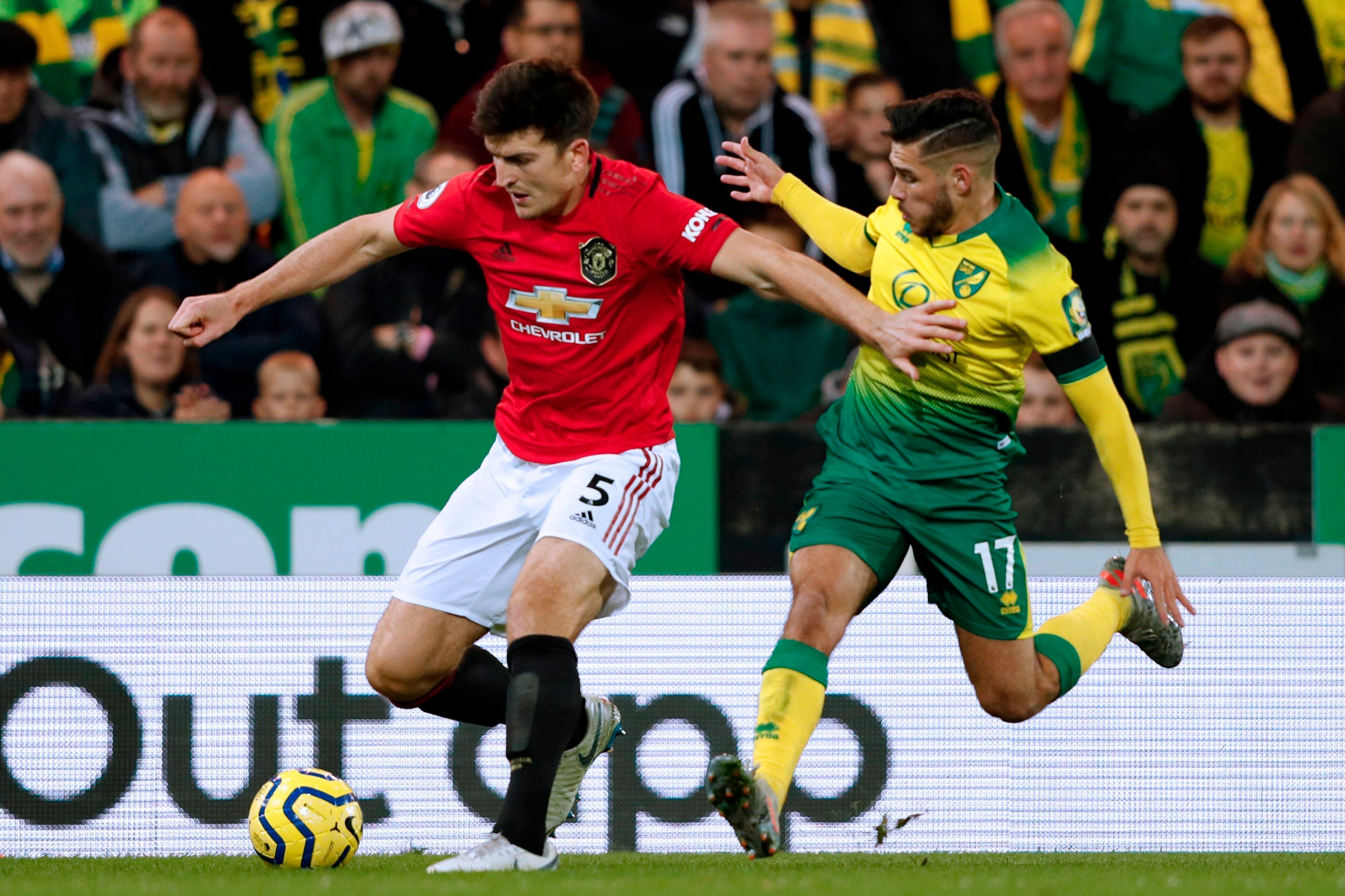 Manchester United's English defender Harry Maguire (L) vies with Norwich City's Argentinian midfielder Emiliano Buendía (R) during the English Premier League football match between Norwich City and Manchester United at Carrow Road in Norwich, eastern Engl