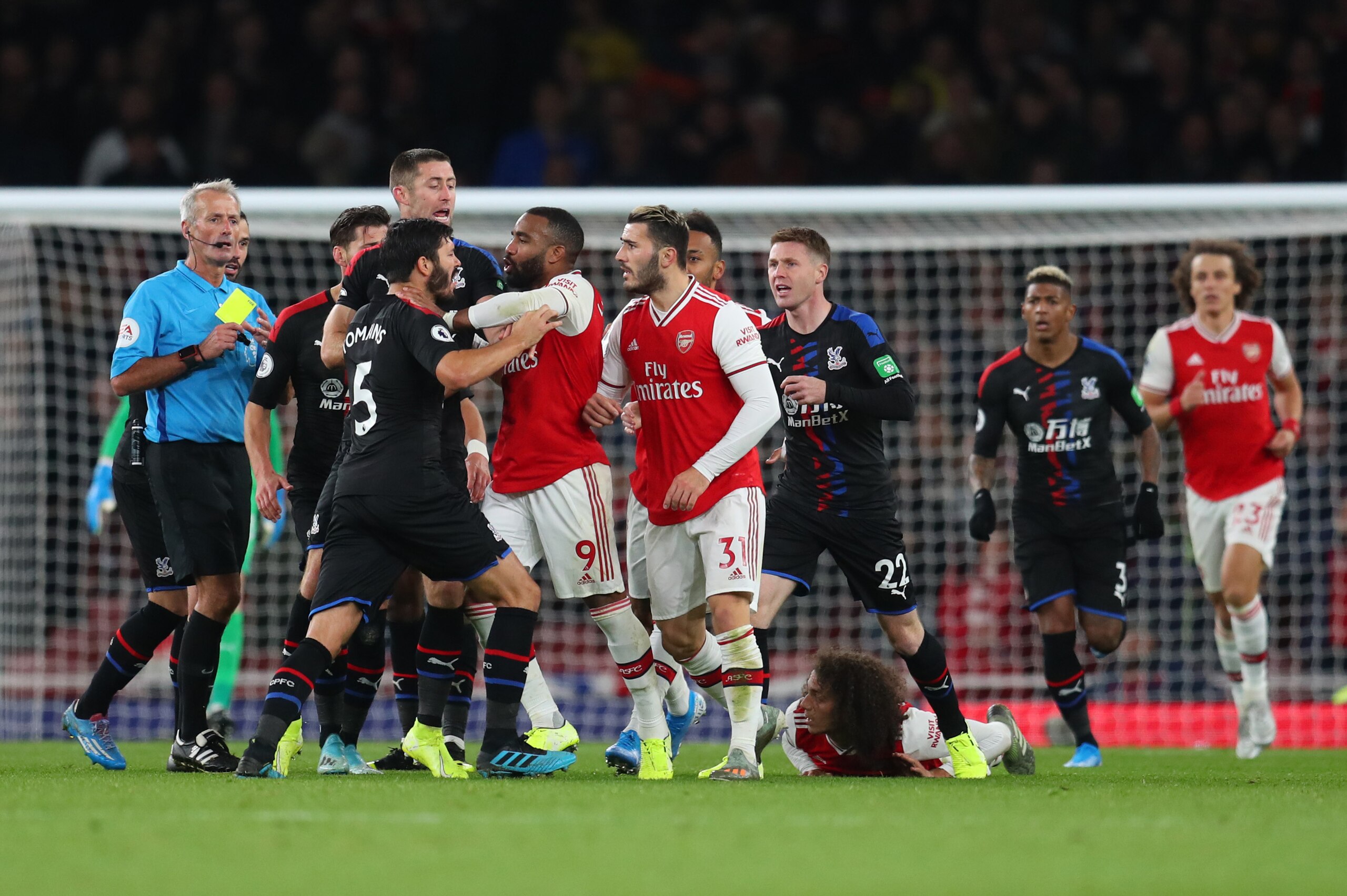 LONDON, ENGLAND - OCTOBER 27: James Tomkins of Crystal Palace and Alexandre Lacazette of Arsenal react during the Premier League match between Arsenal FC and Crystal Palace at Emirates Stadium on October 27, 2019 in London, United Kingdom. (Photo by Cathe