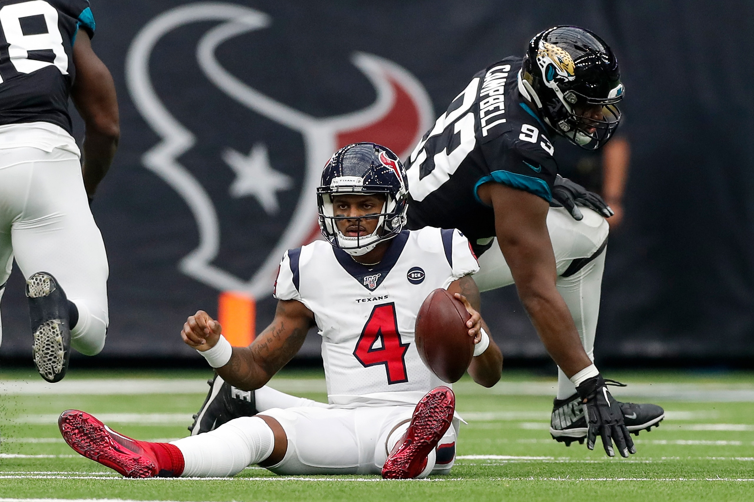 HOUSTON, TX - SEPTEMBER 15:  Deshaun Watson #4 of the Houston Texans reacts after a sack by Calais Campbell #93 of the Jacksonville Jaguars in the first half at NRG Stadium on September 15, 2019 in Houston, Texas.  (Photo by Tim Warner/Getty Images)