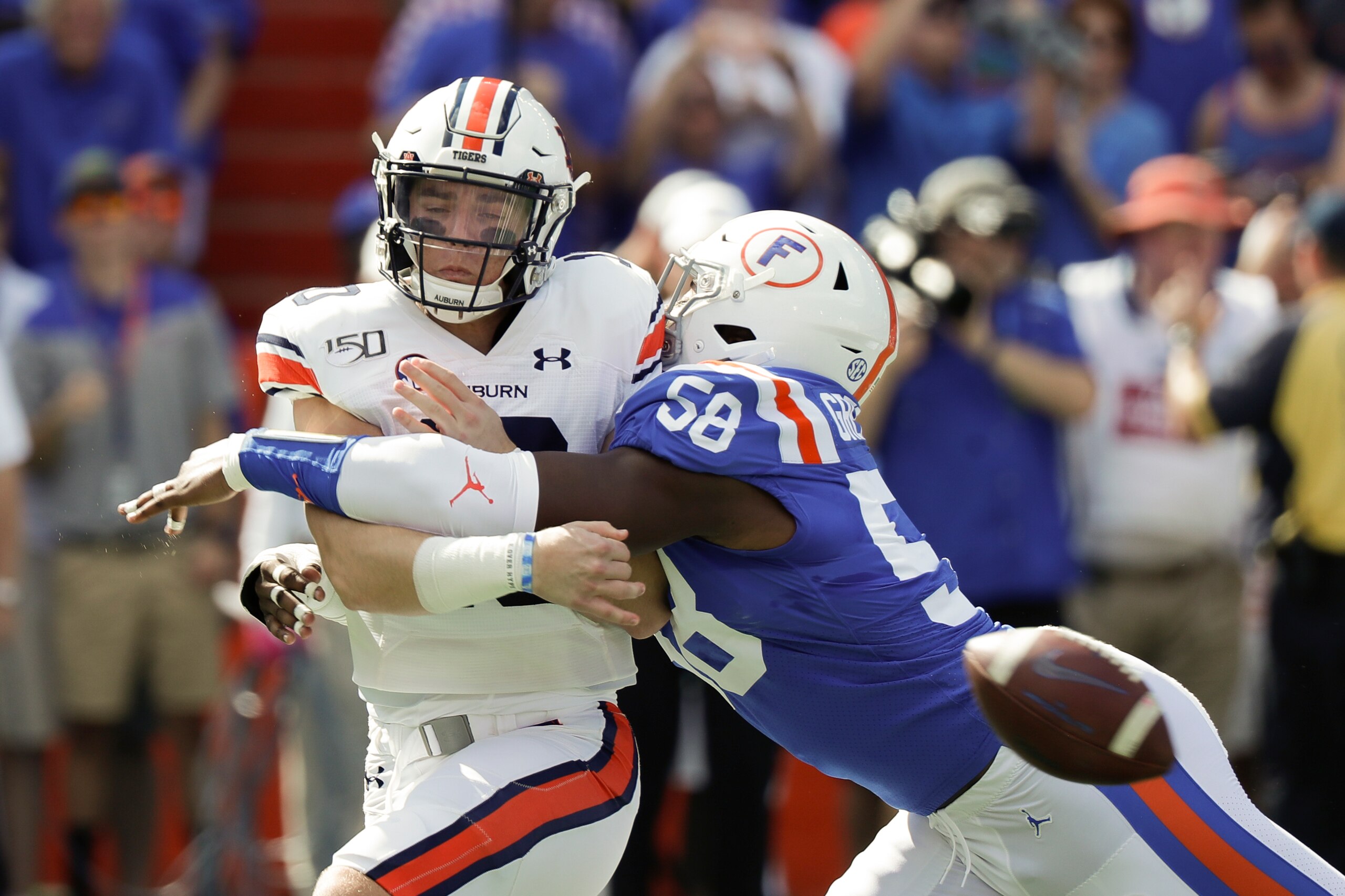 Florida edge-rusher Jonathan Greenard delivers a hit to Auburn QB Bo Nix