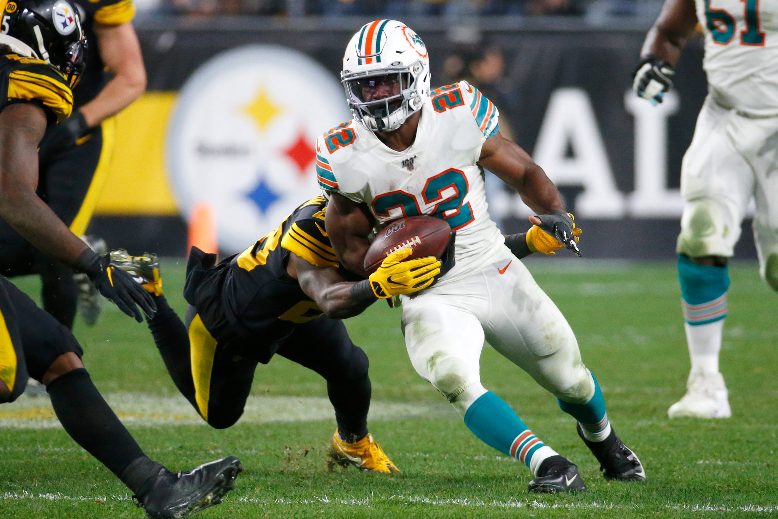 PITTSBURGH, PA - OCTOBER 28: Bobby McCain #28 of the Miami Dolphins strips Mark Walton #22 of the Miami Dolphins in the second half on October 28, 2019 at Heinz Field in Pittsburgh, Pennsylvania. (Photo by Justin K. Aller/Getty Images)